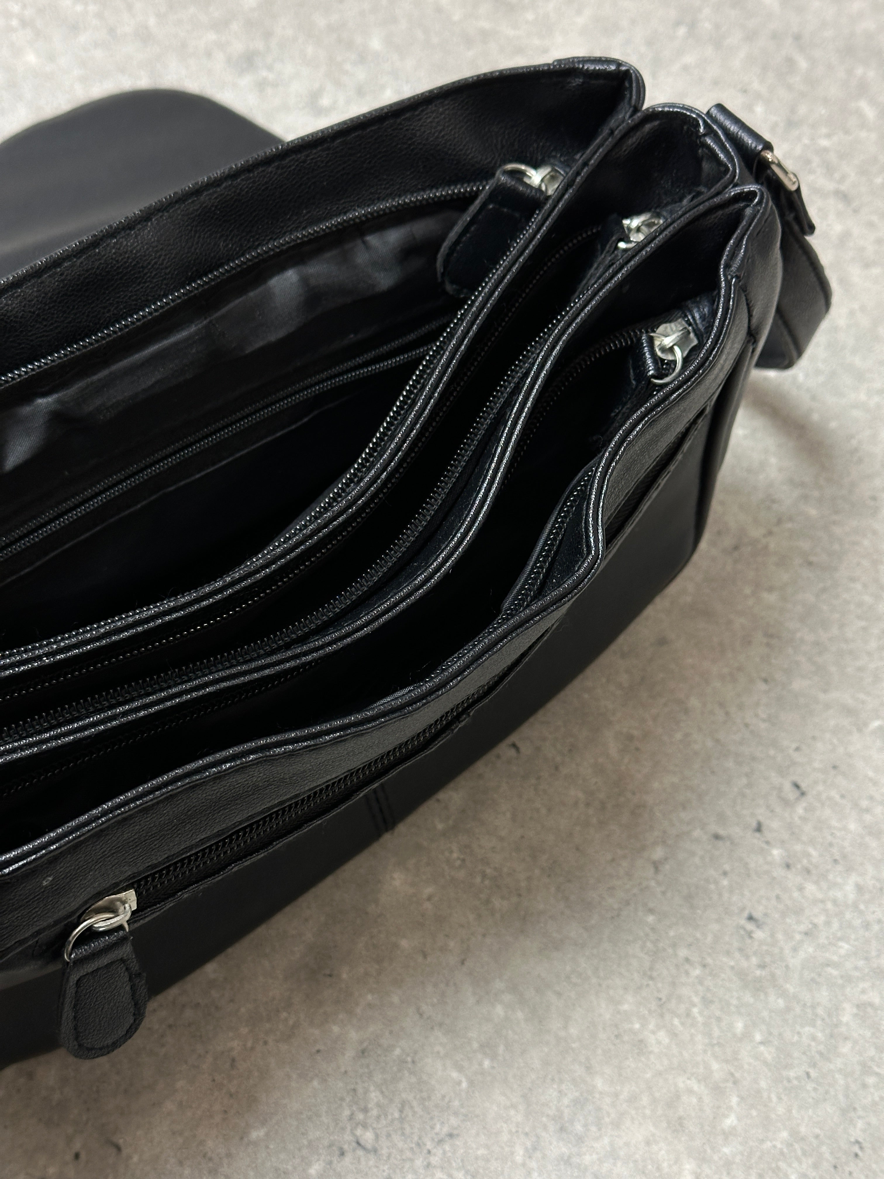 Vintage faux leather crossbody bag with adjustable strap and classic design, featuring a sleek and stylish look.