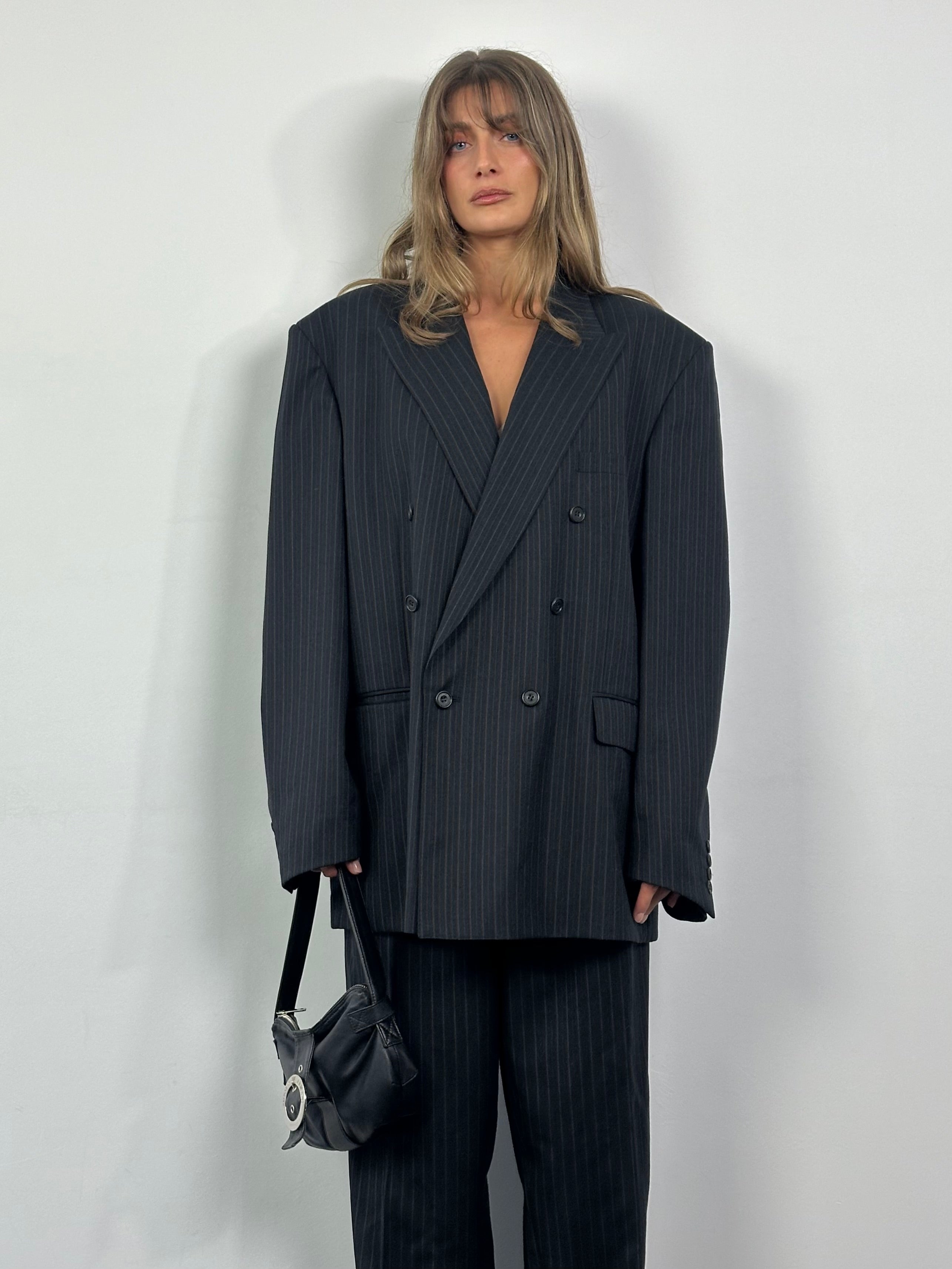 Christian Dior Monsieur 1990s pure wool pinstripe double-breasted suit, size 46L/W32, hanging on a clothing rack.