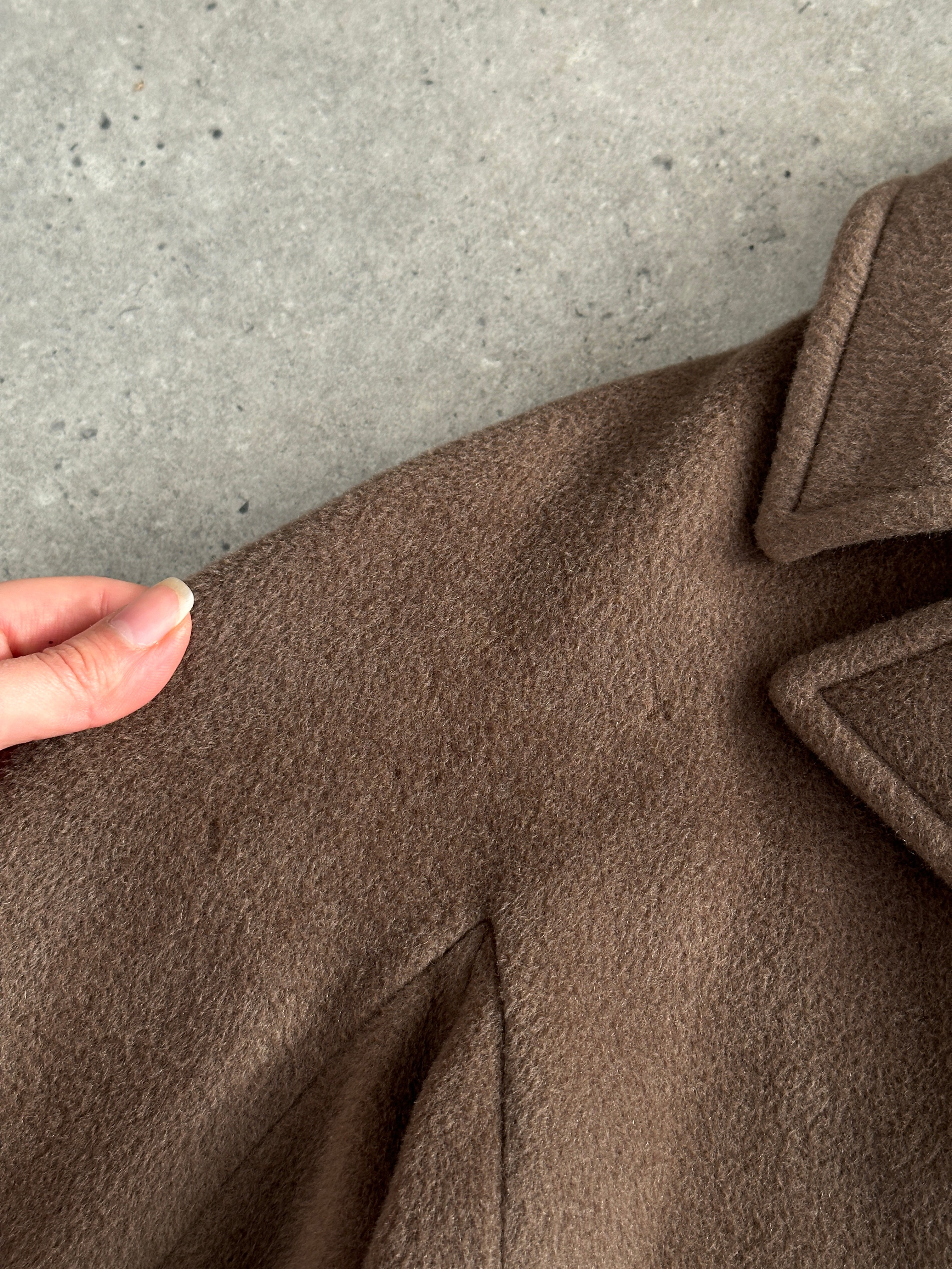 Max Mara pure wool double-breasted coat in size S displayed on a hanger, showcasing classic tailored design and neutral color.