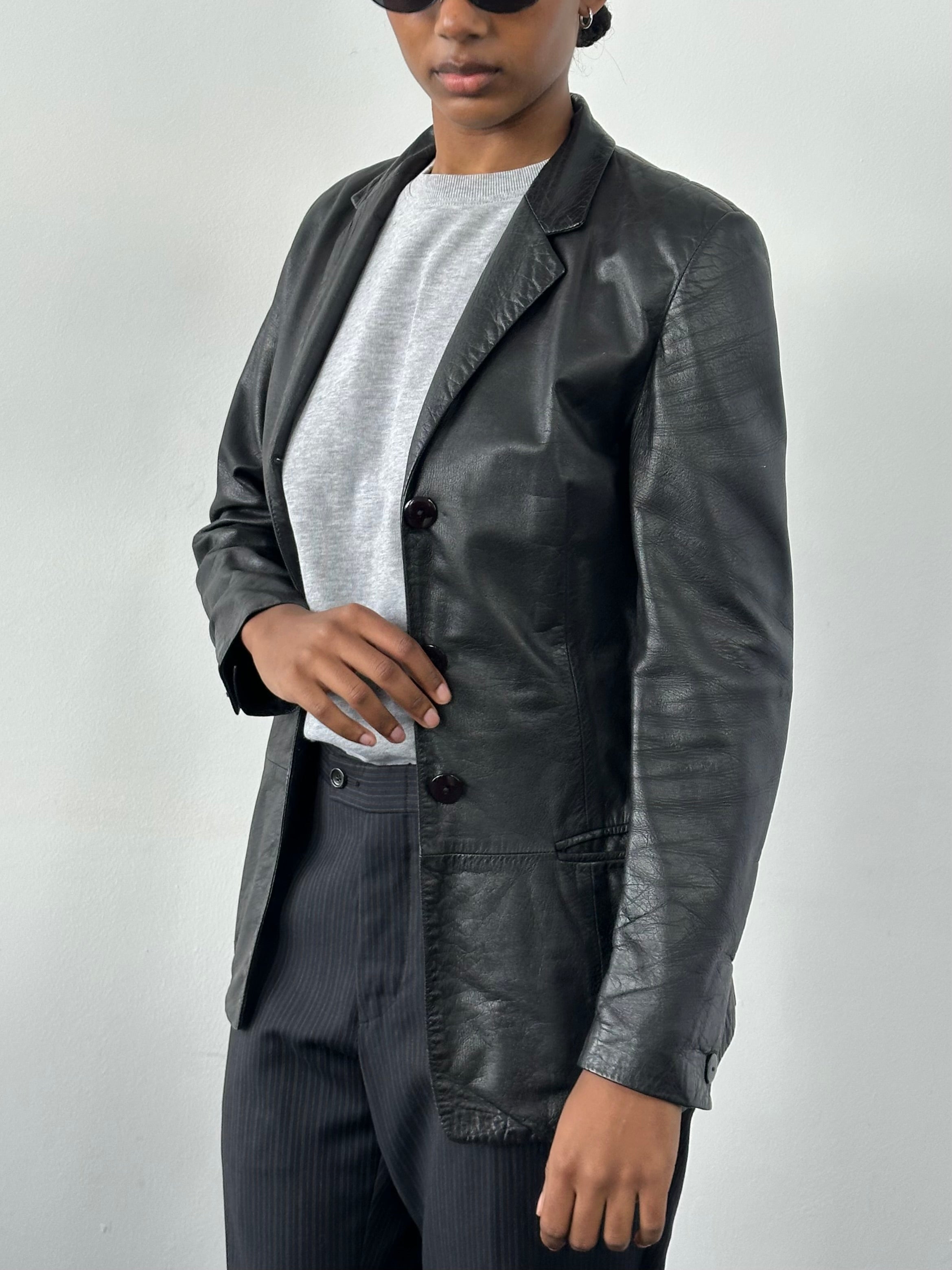 Versace 1990s fitted leather jacket in XS with classic design, black leather, and signature details displayed in the image.