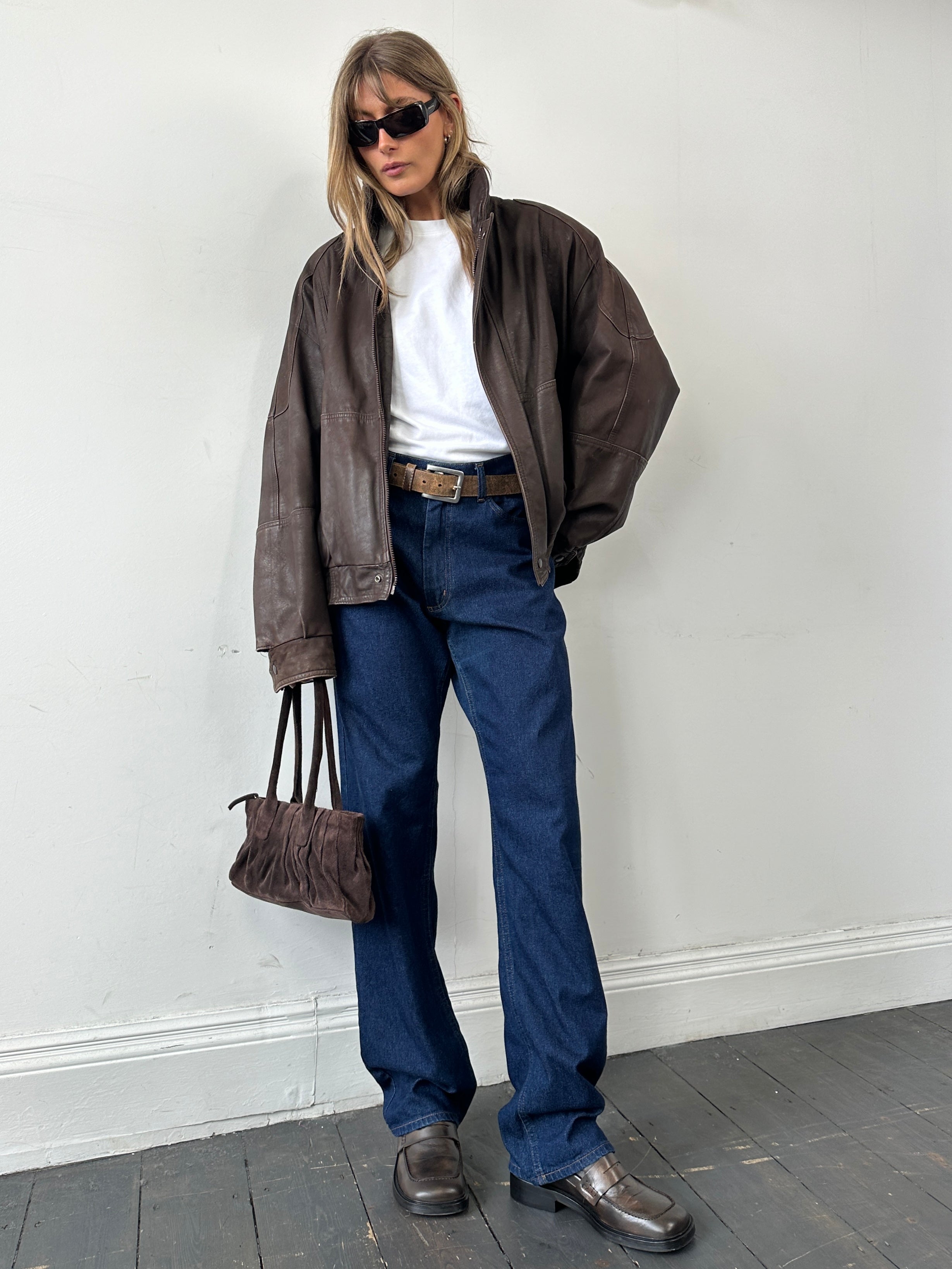 Vintage leather bomber jacket in XL size, featuring classic design with a rugged, worn-in look and detailed stitching.