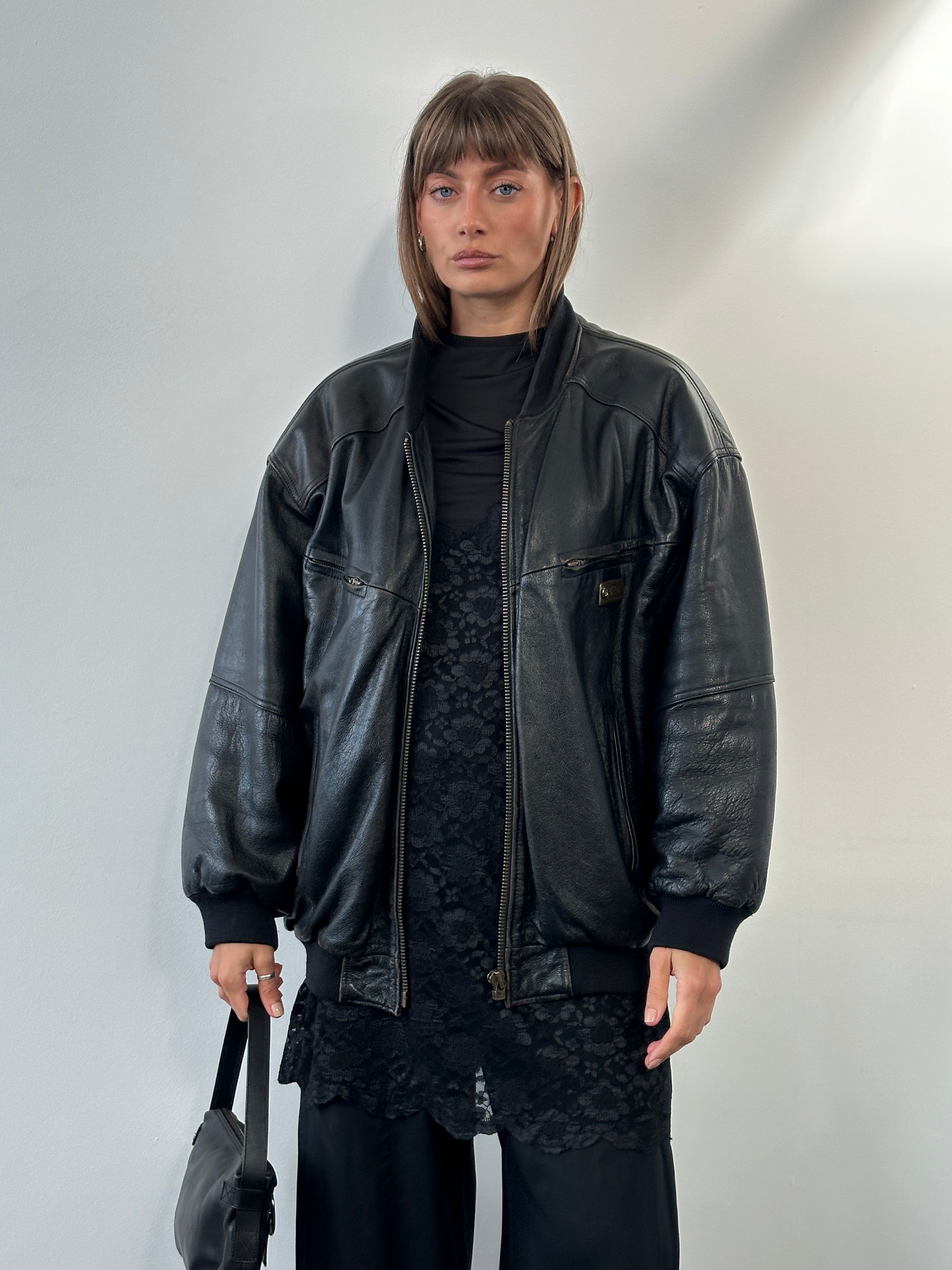 Vintage BMW 1990s leather bomber jacket, XL size, featuring classic design, brown leather exterior, and ribbed collar and cuffs.