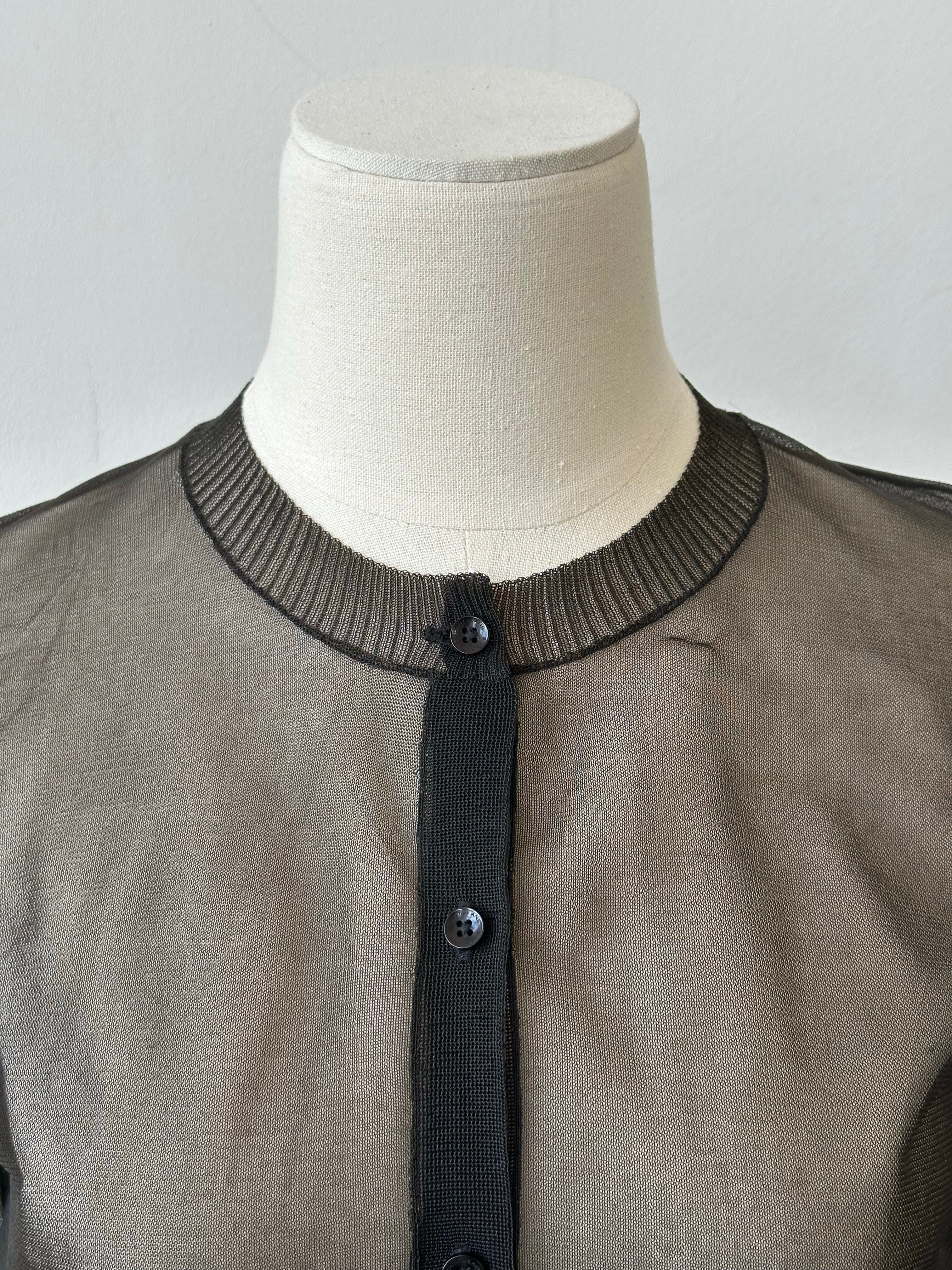 DKNY 1990s sheer knit cardigan in size S, featuring lightweight, transparent fabric and classic design, displayed on a hanger.