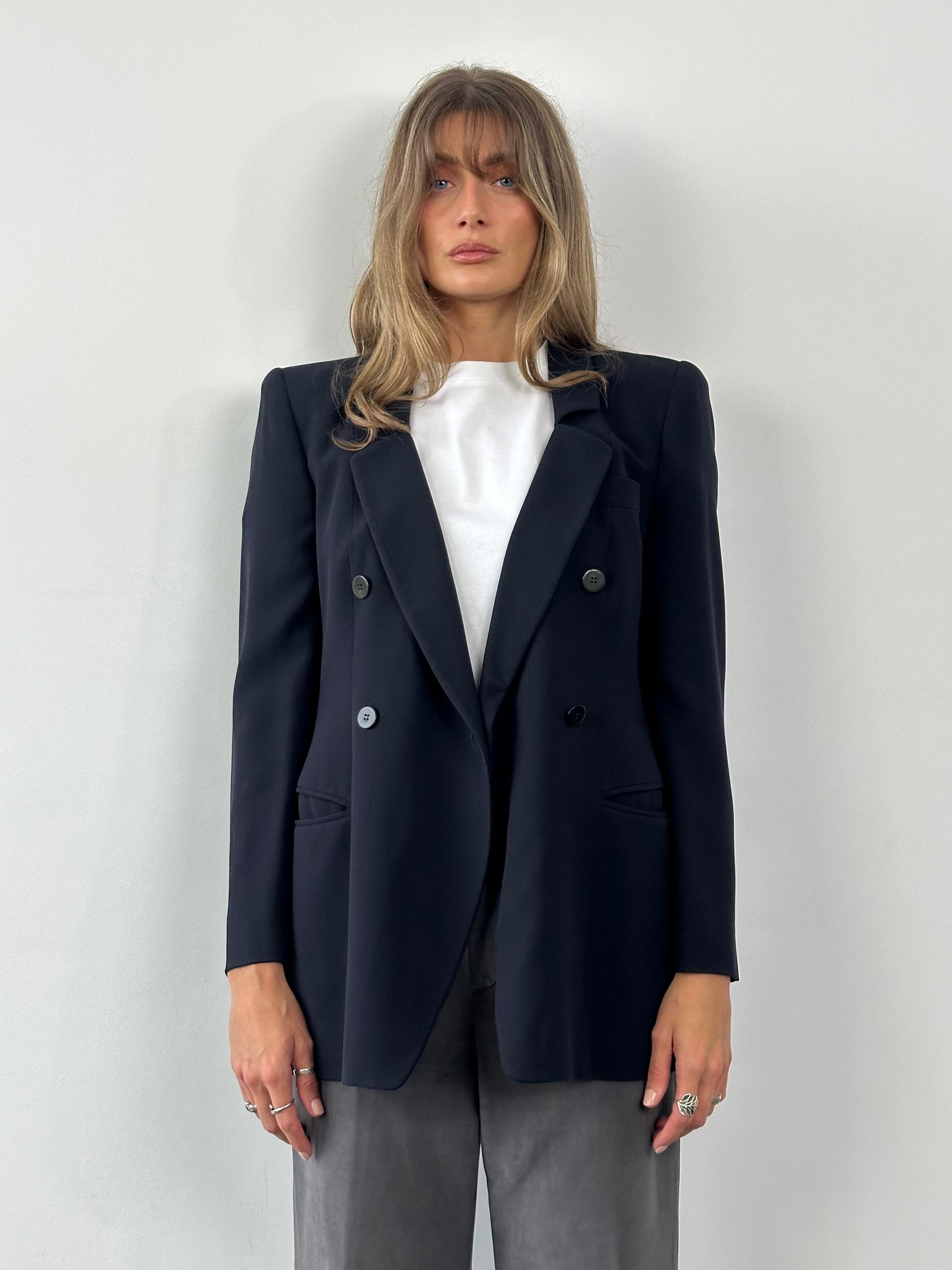 Giorgio Armani Black Label pure wool fitted blazer in black, displayed on a hanger, with a tailored collar and sleek design.