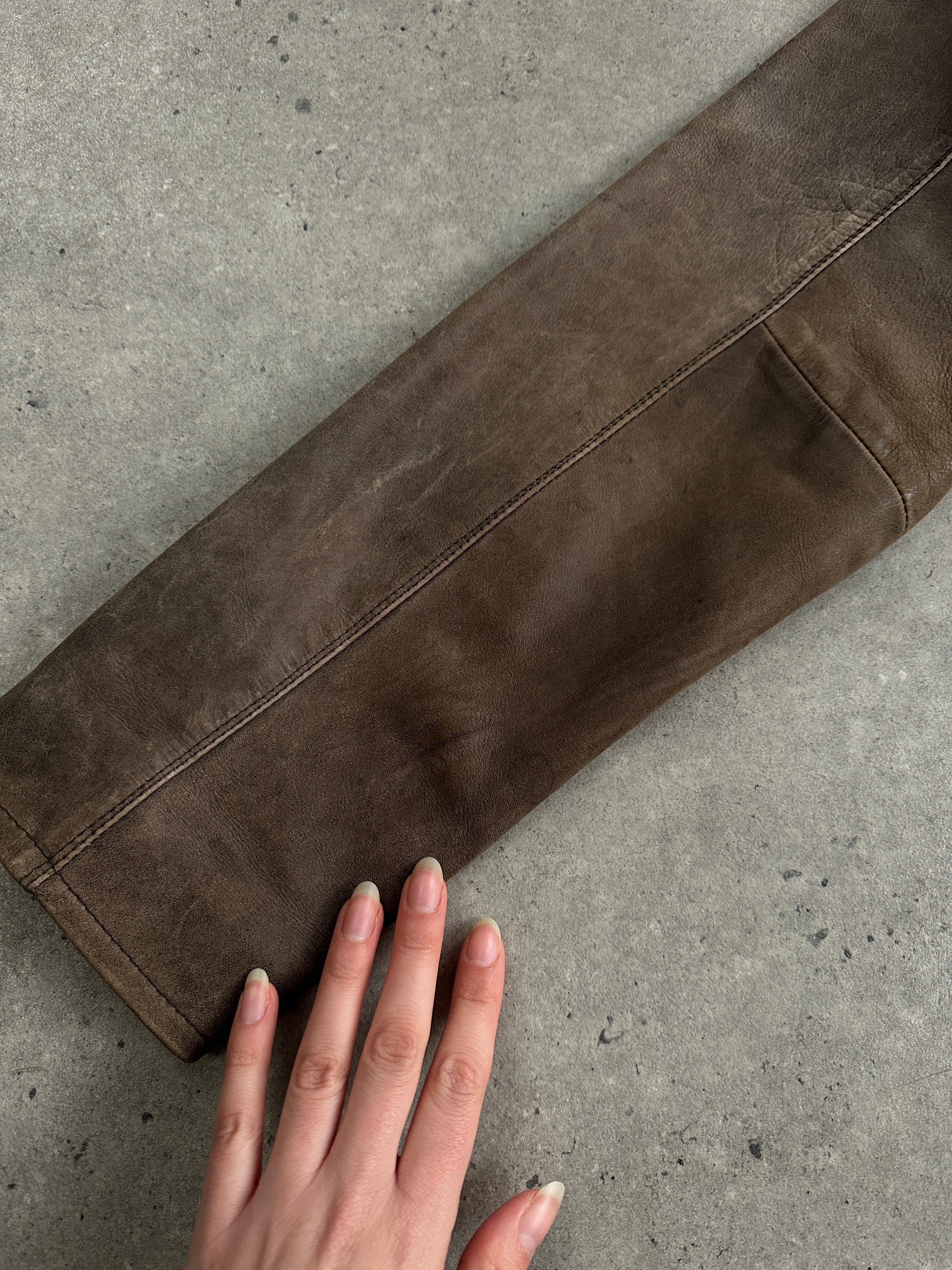 Vintage distressed leather jacket in size large, featuring a rugged, worn-in look with classic style and detailed stitching.