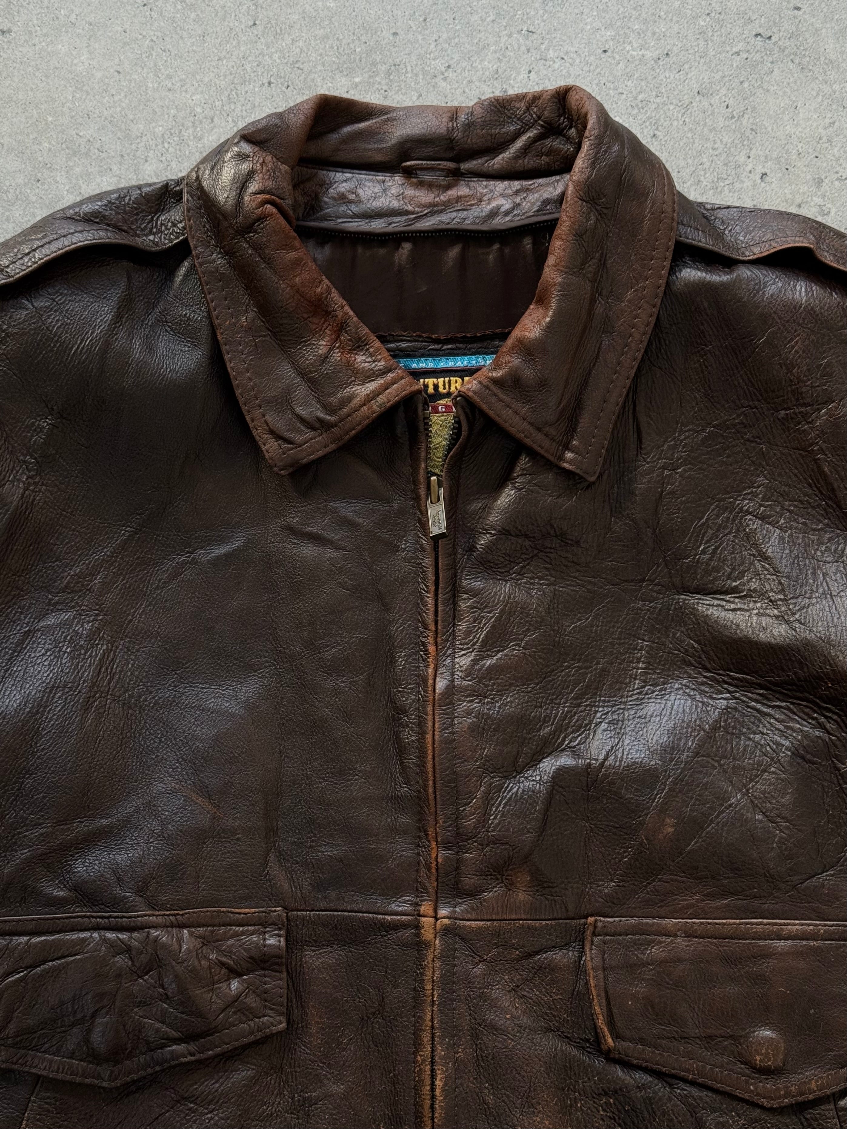Vintage 1990s distressed leather bomber jacket in XL size, featuring rugged style and classic design.