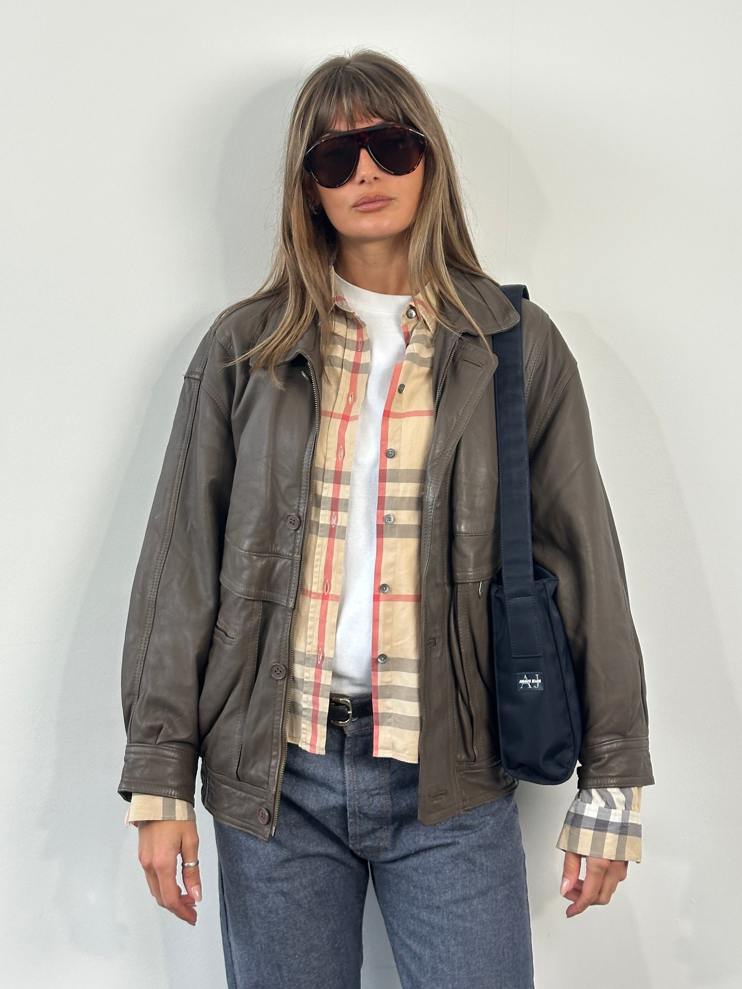 Vintage 1990s leather bomber jacket in medium size with classic design and brown leather material.