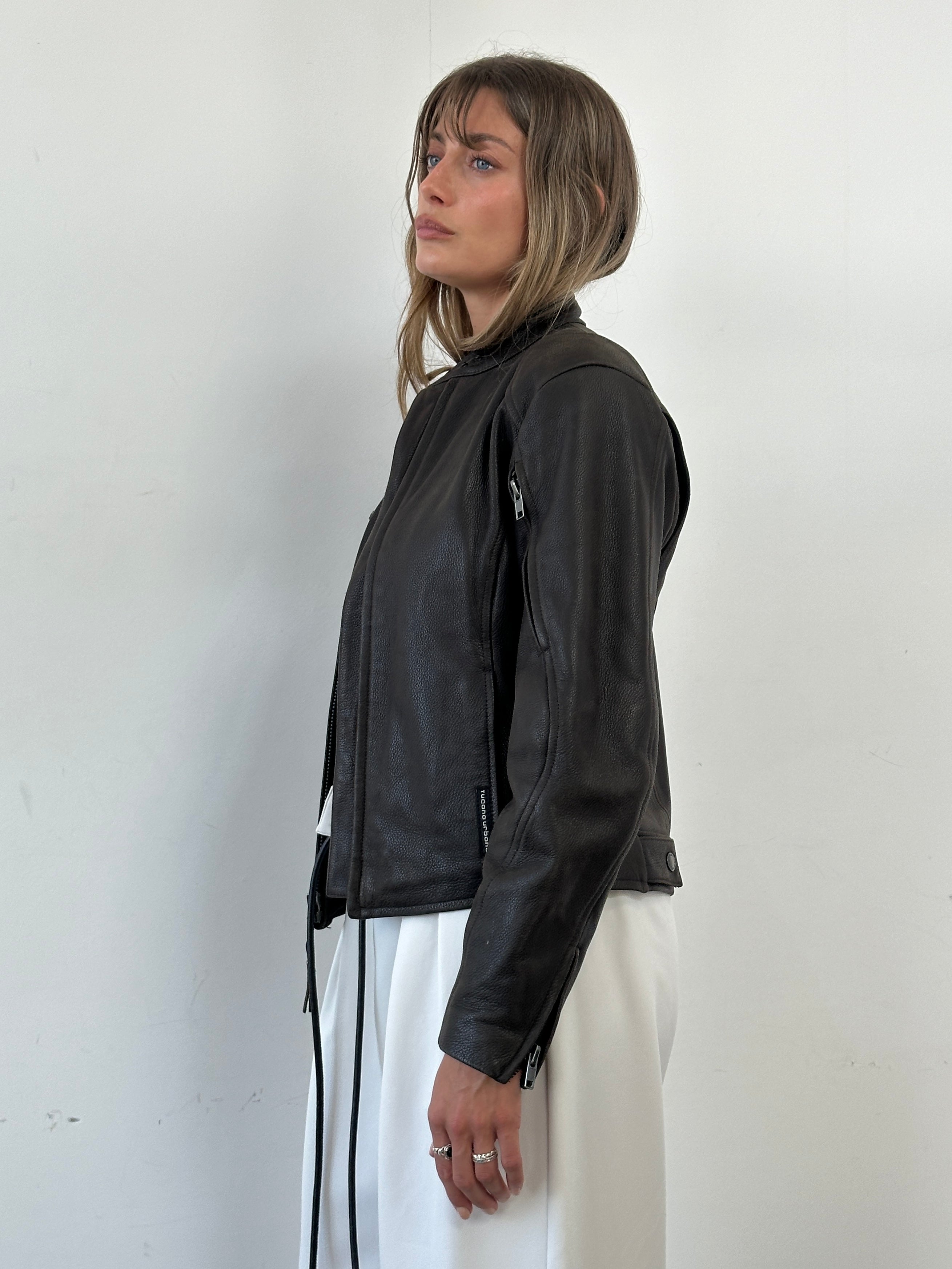 Vintage leather moto jacket in size S/M, featuring classic design with a sleek black finish and detailed stitching.
