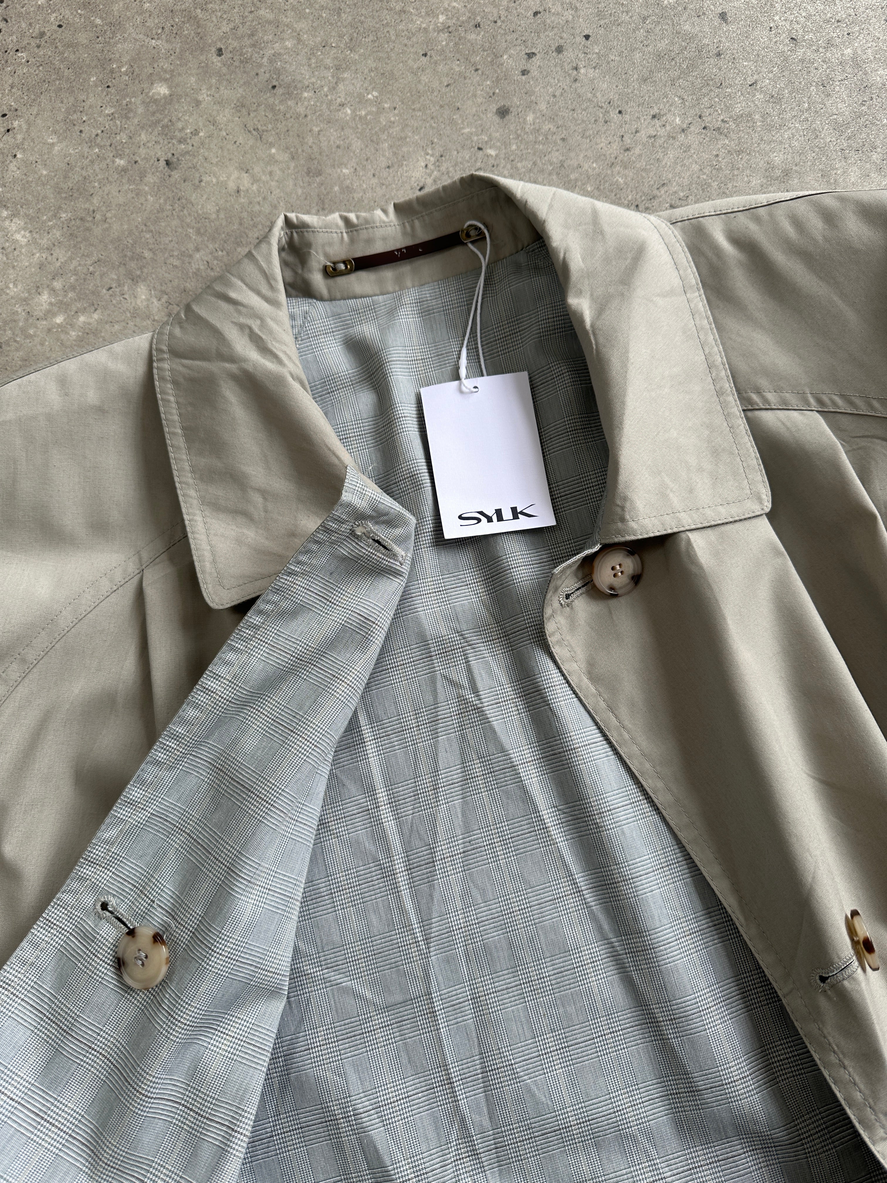 Vintage reversible showerproof check belted trench coat, size large, featuring classic plaid pattern and durable waterproof fabric.