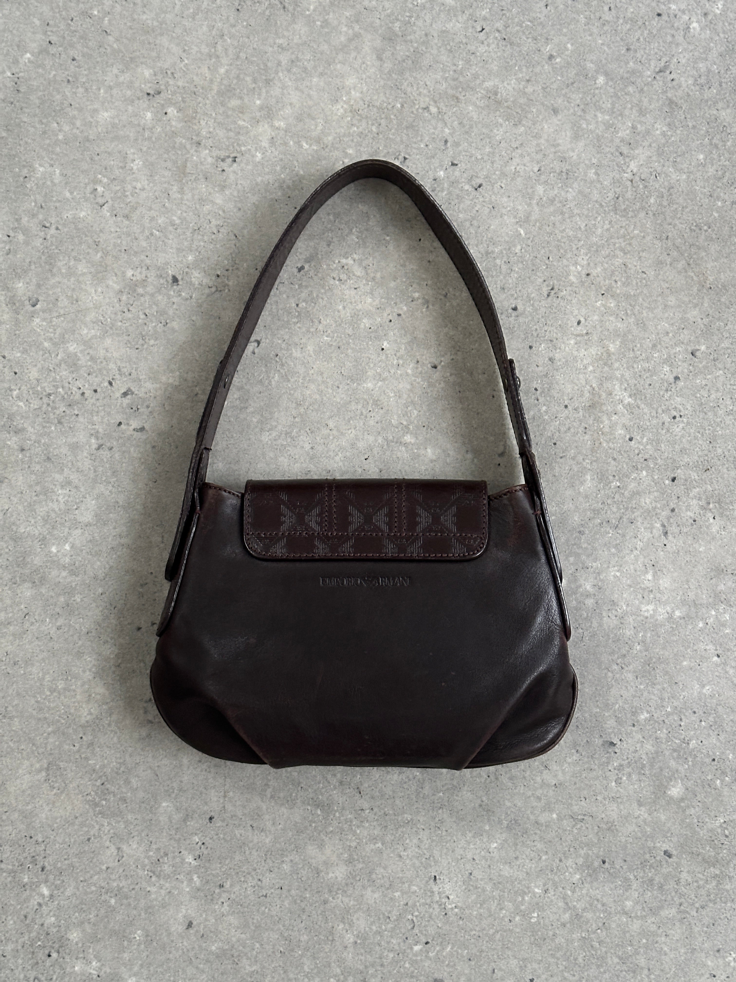 Emporio Armani leather shoulder bag with hardware monogram design, featuring a sleek strap and elegant craftsmanship.