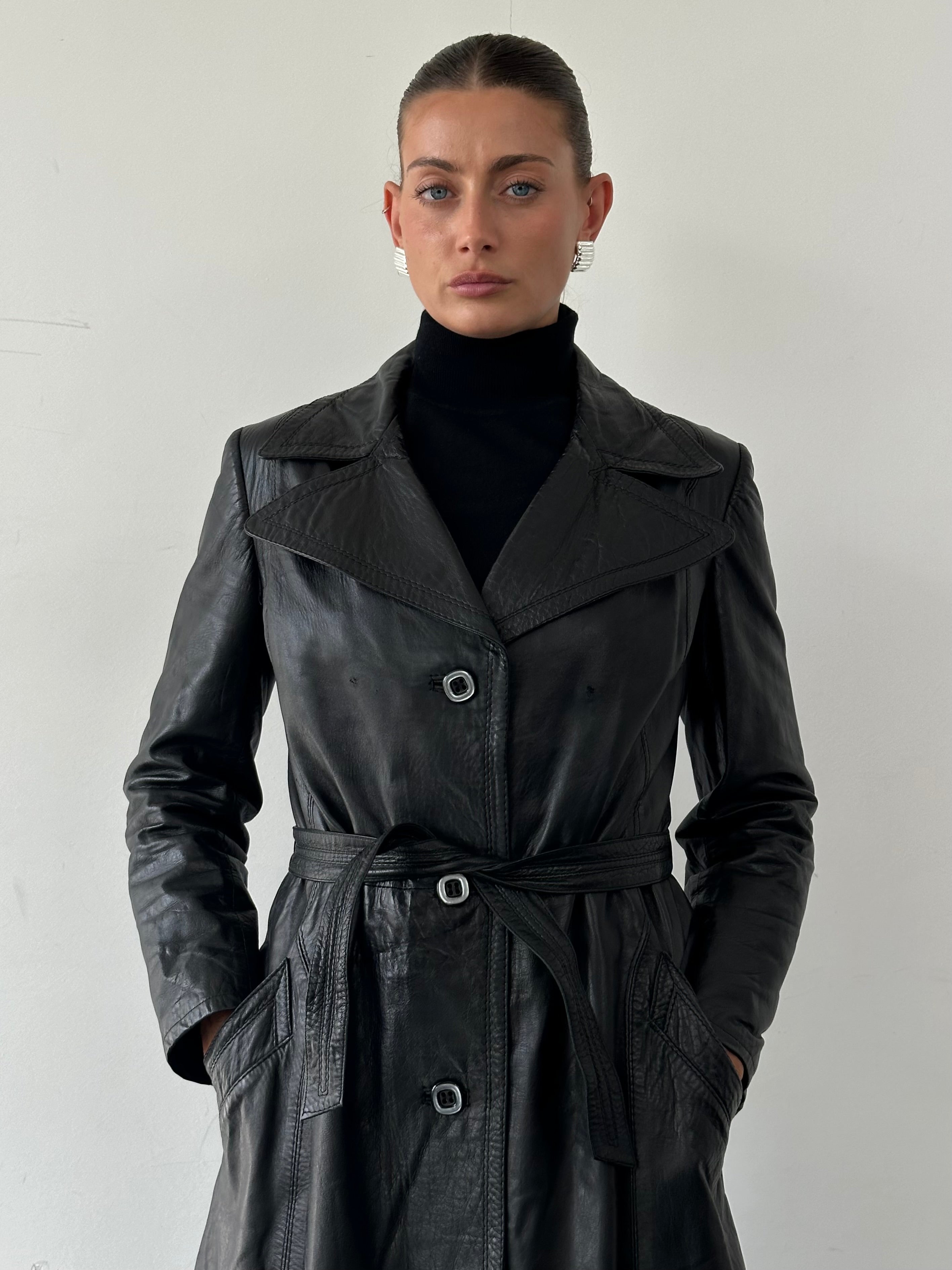 Vintage Italian leather trench coat with belt, classic and stylish, shown in size M with detailed features and timeless design.