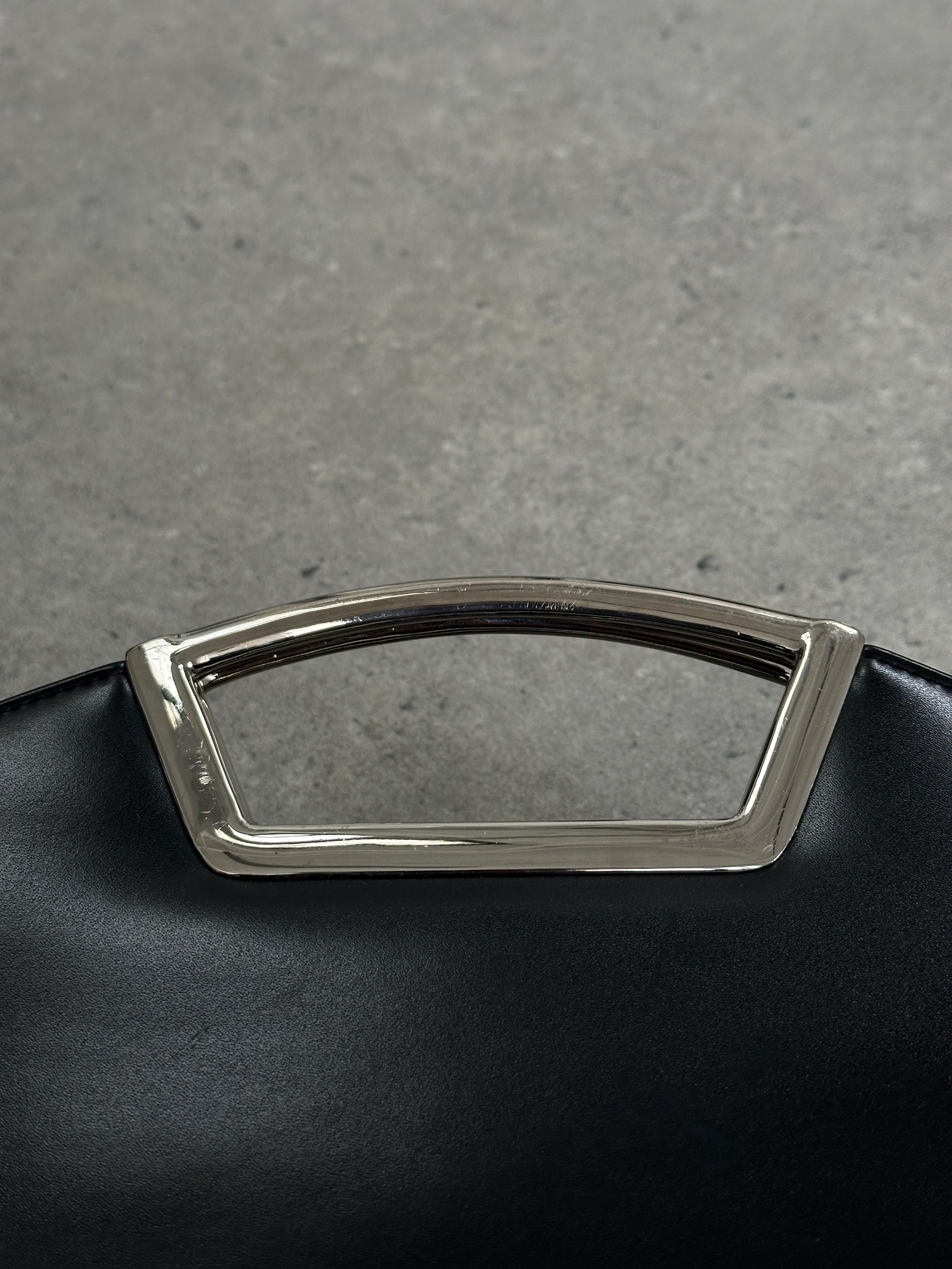 Vintage leather chrome crossbody clutch bag with a sleek design, featuring a compact shape and adjustable strap.