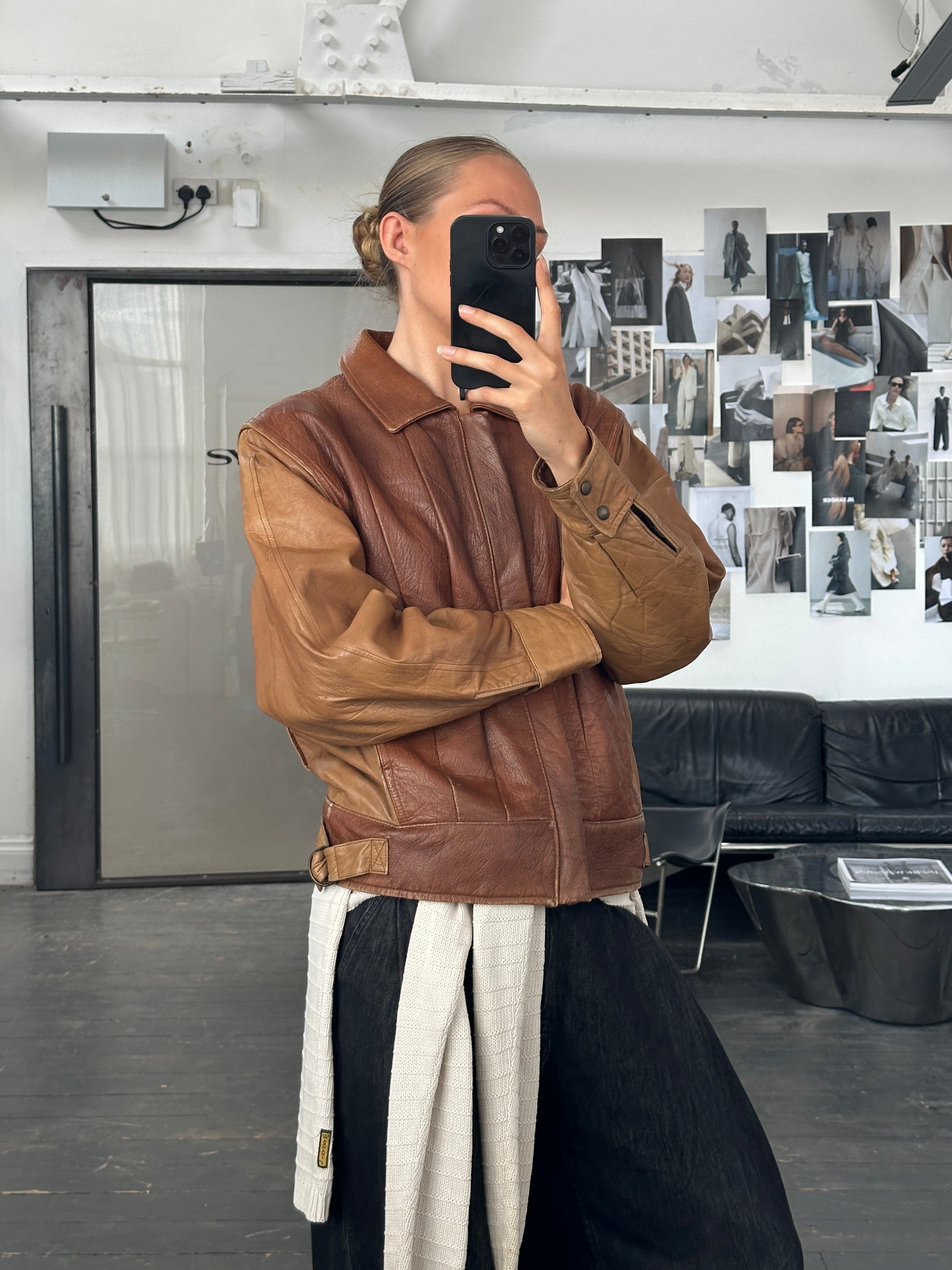 Vintage Italian leather bomber jacket from the 1980s, in size M/L, featuring classic design and distressed leather details.