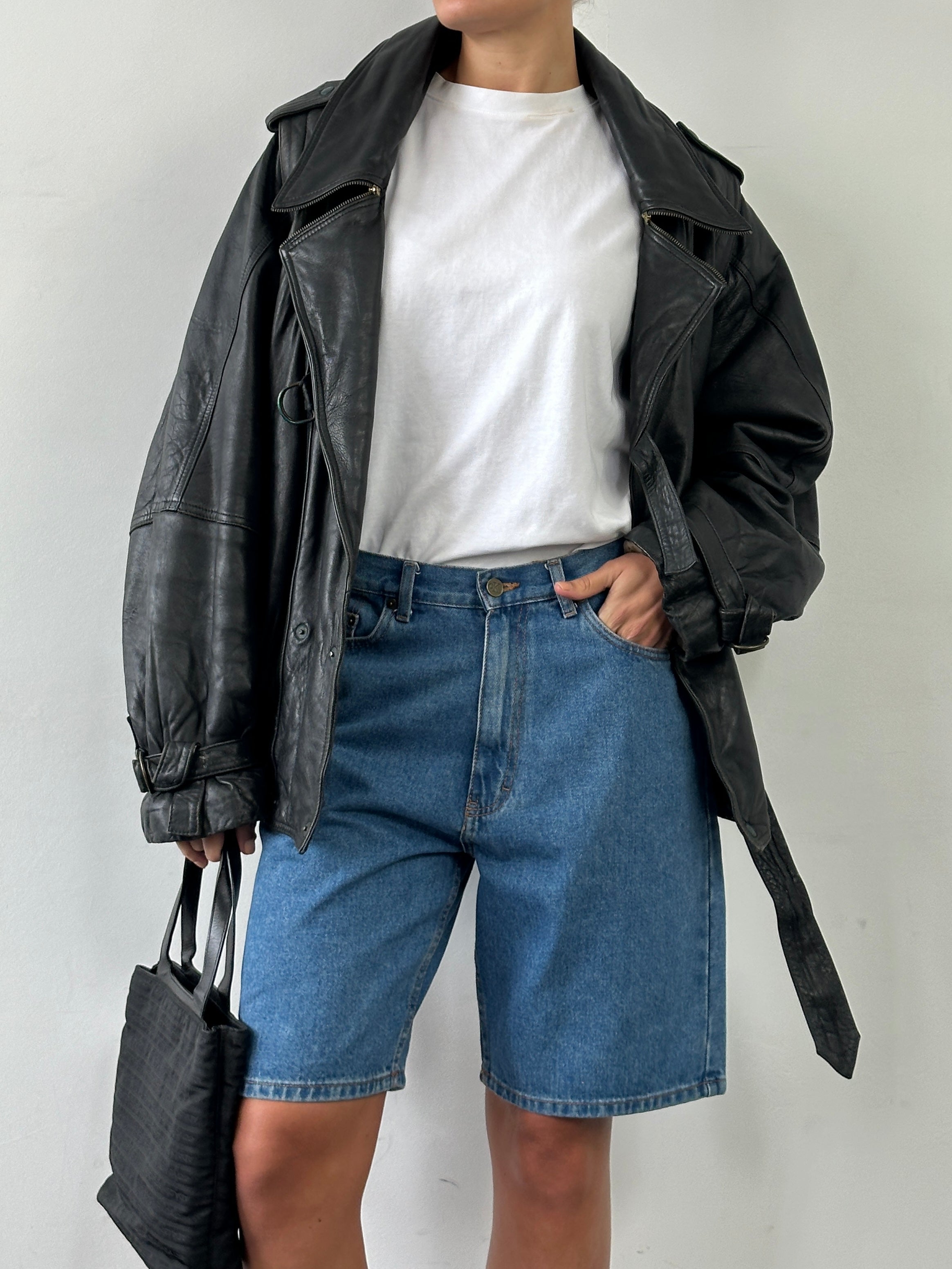 Calvin Klein CK loose leg denim shorts in W32 laid flat, showcasing classic blue wash and relaxed fit design.