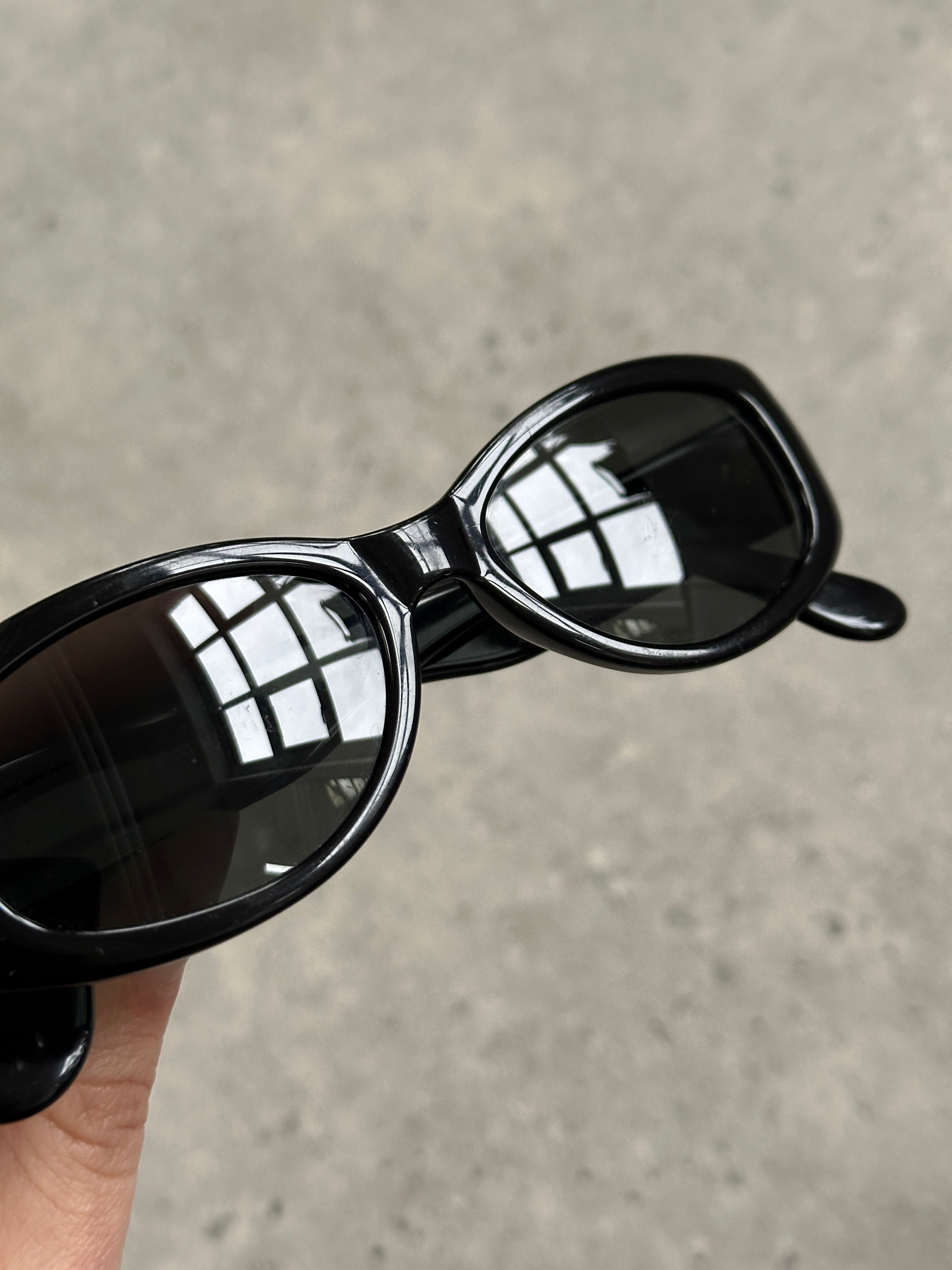 Emporio Armani 2000s oval sunglasses with black frames and dark tinted lenses, stylish eyewear from the Armani sunglasses collection.
