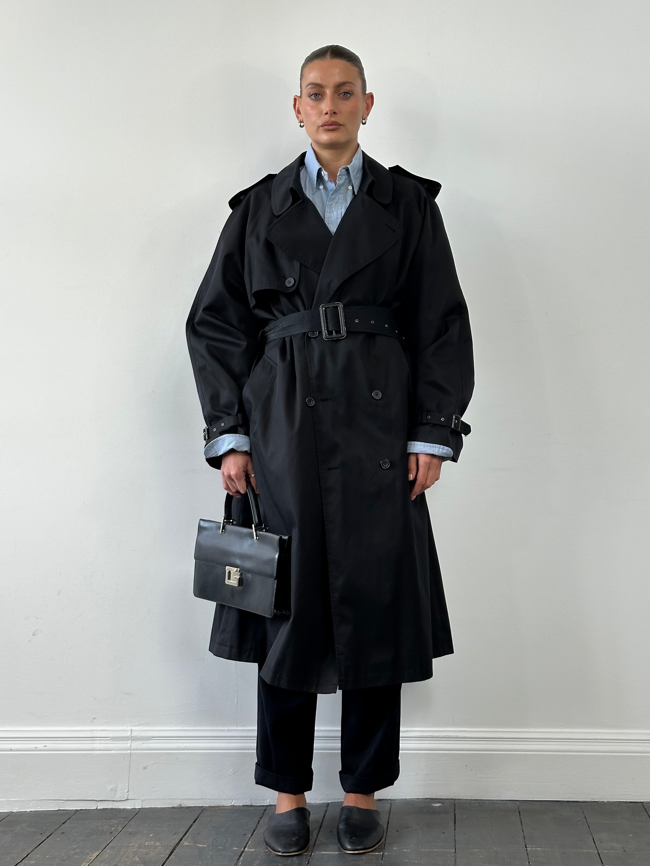 Vintage double-breasted belted trench coat in size XL, featuring classic design, collar, and button details.