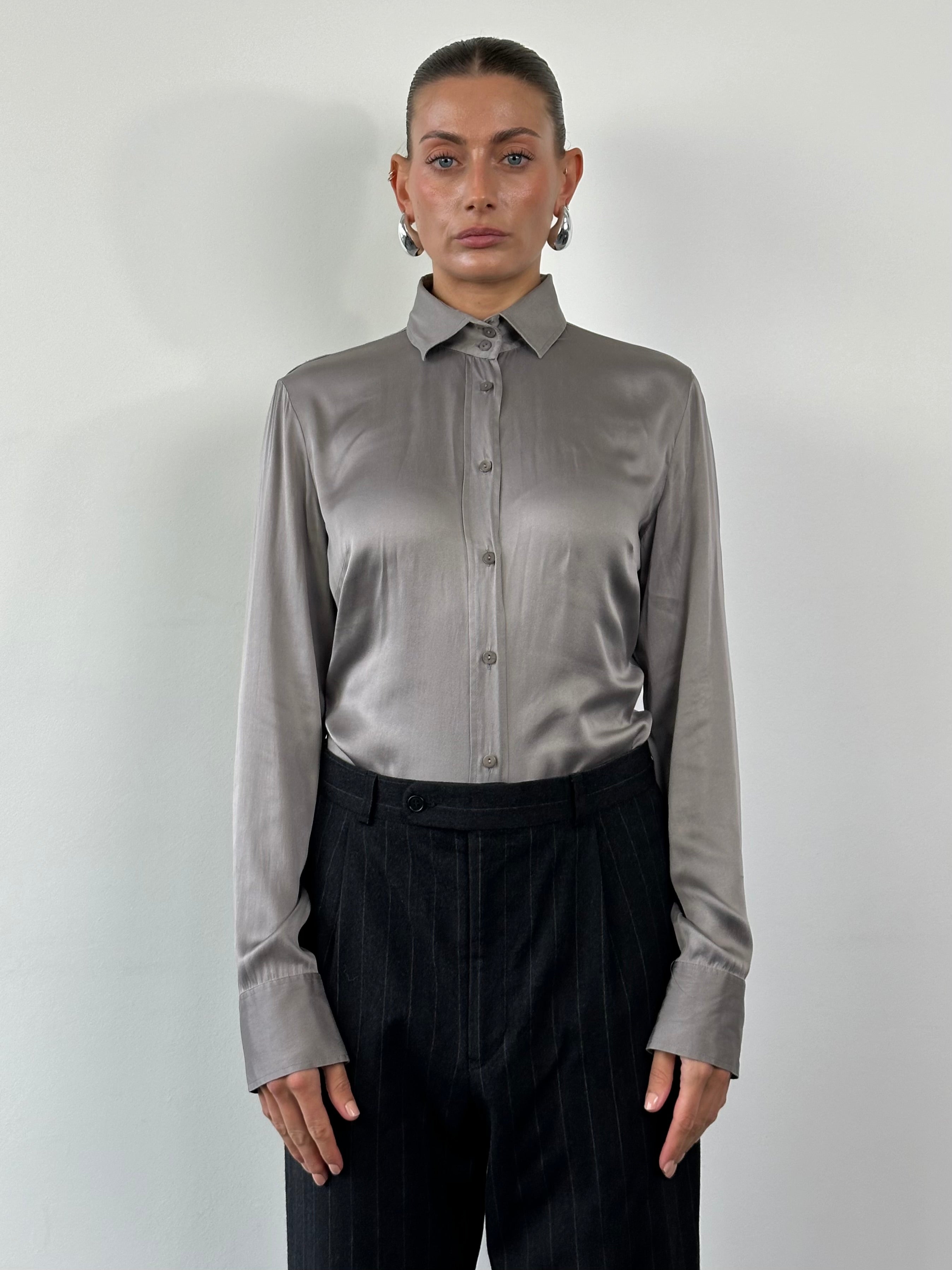 Vintage silk shirt in size M, featuring a classic design with a smooth, shiny fabric and a relaxed fit.
