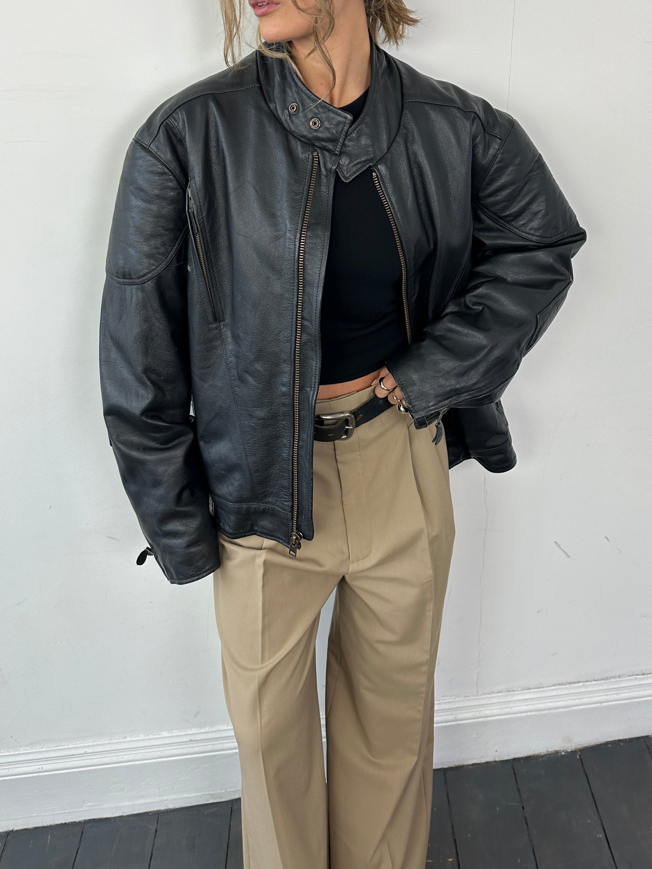 Vintage leather motorcycle jacket in XL size, featuring classic design, rugged texture, and authentic vintage style.