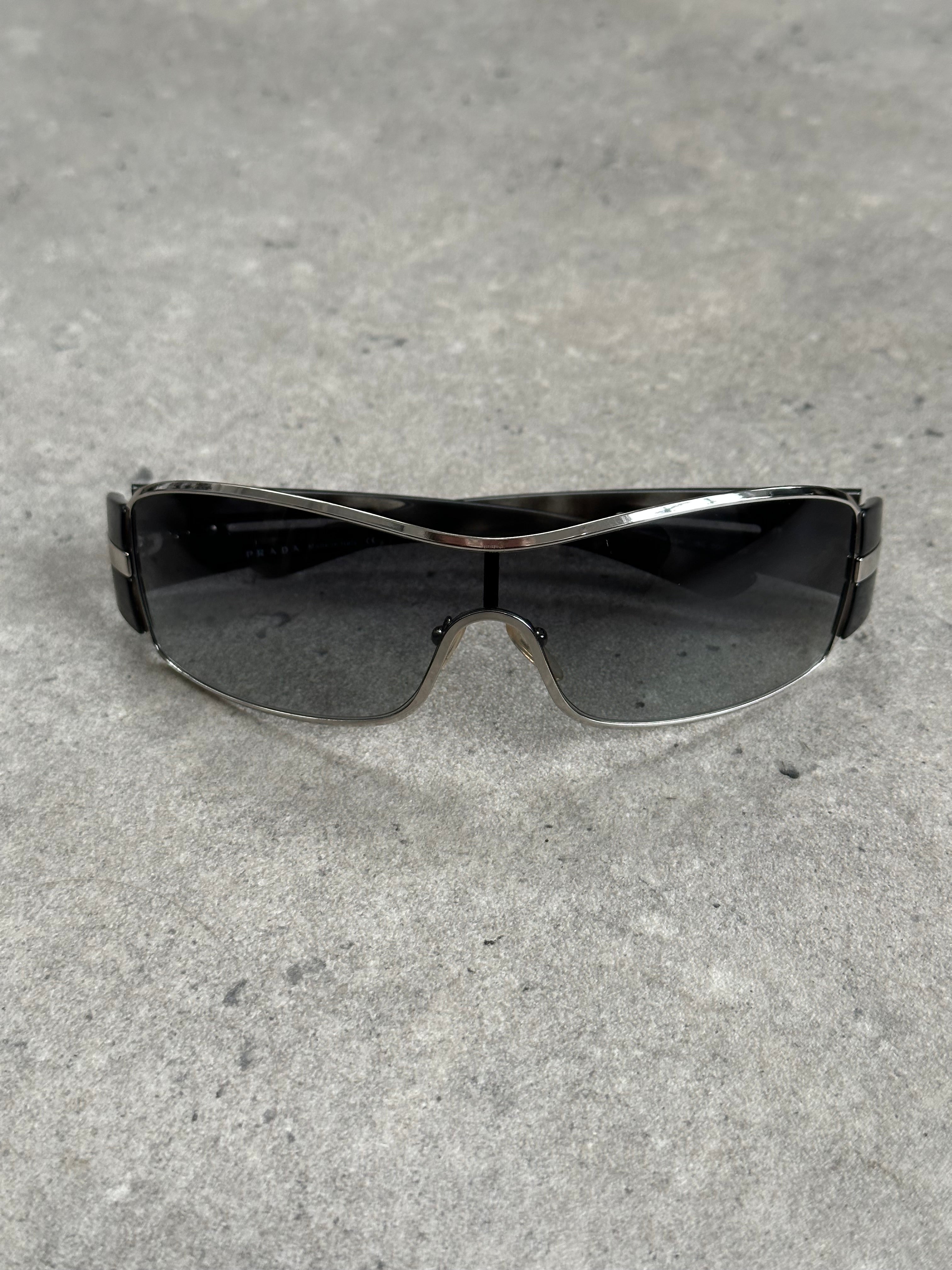 Prada 2000s aviator shield sunglasses with dark tinted lenses and metal frame, stylish and iconic eyewear.