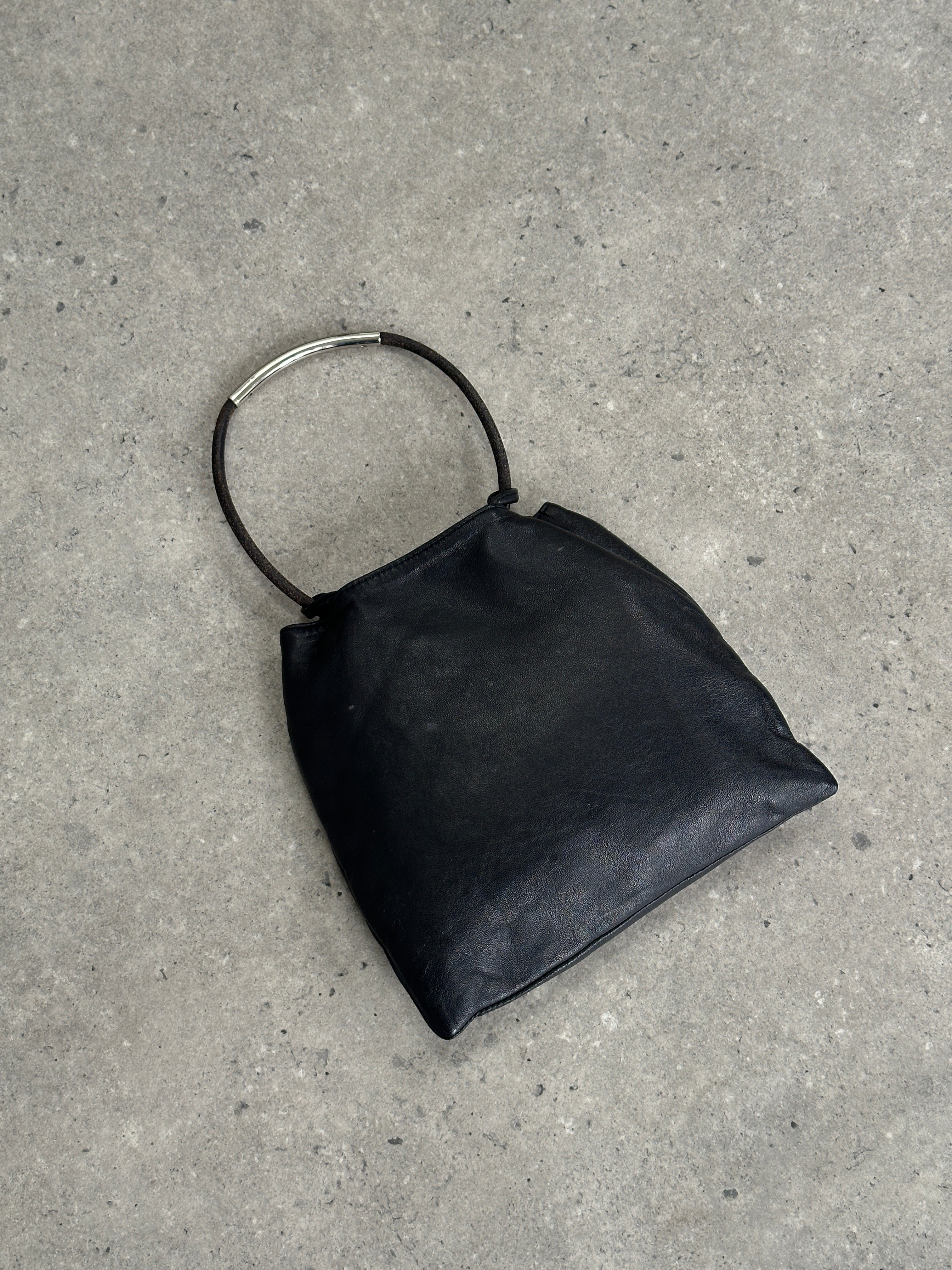 DKNY soft leather clutch bag with sleek design and subtle stitching, perfect for elegant evening or daytime use.