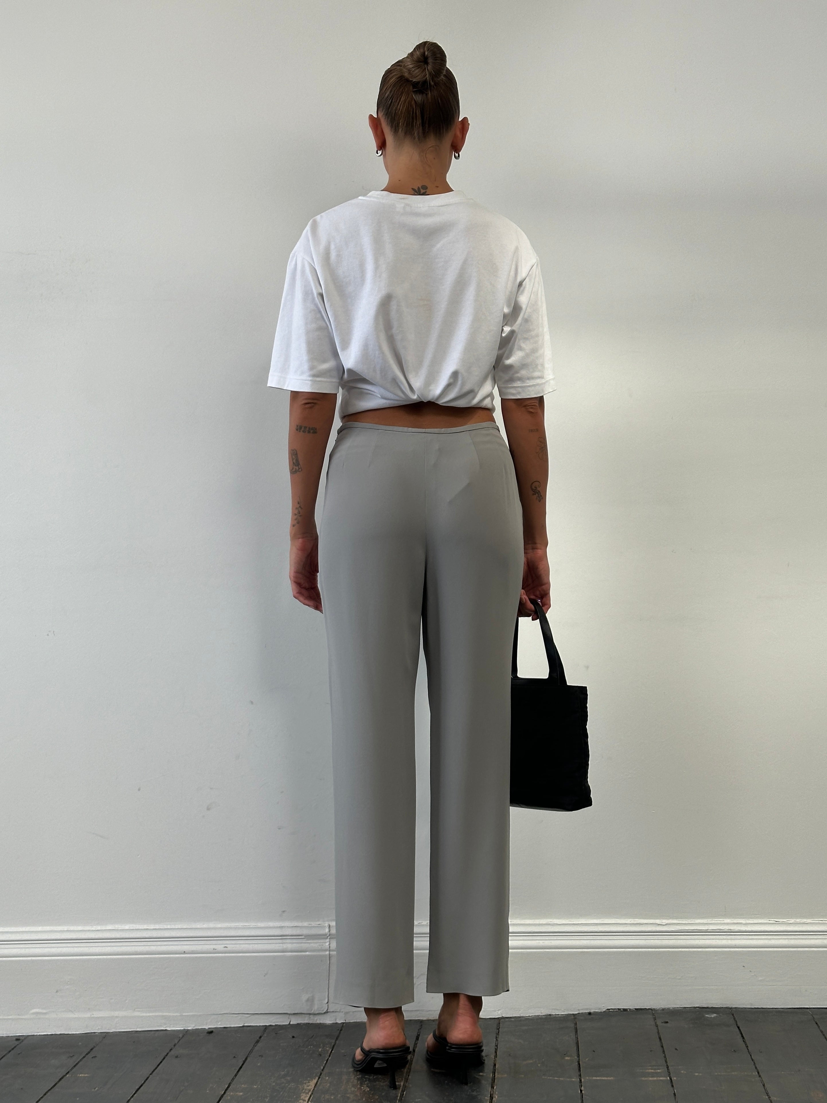 Armani Collezioni high waisted silk trousers in relaxed fit, showcasing smooth fabric and tailored design, size W28.
