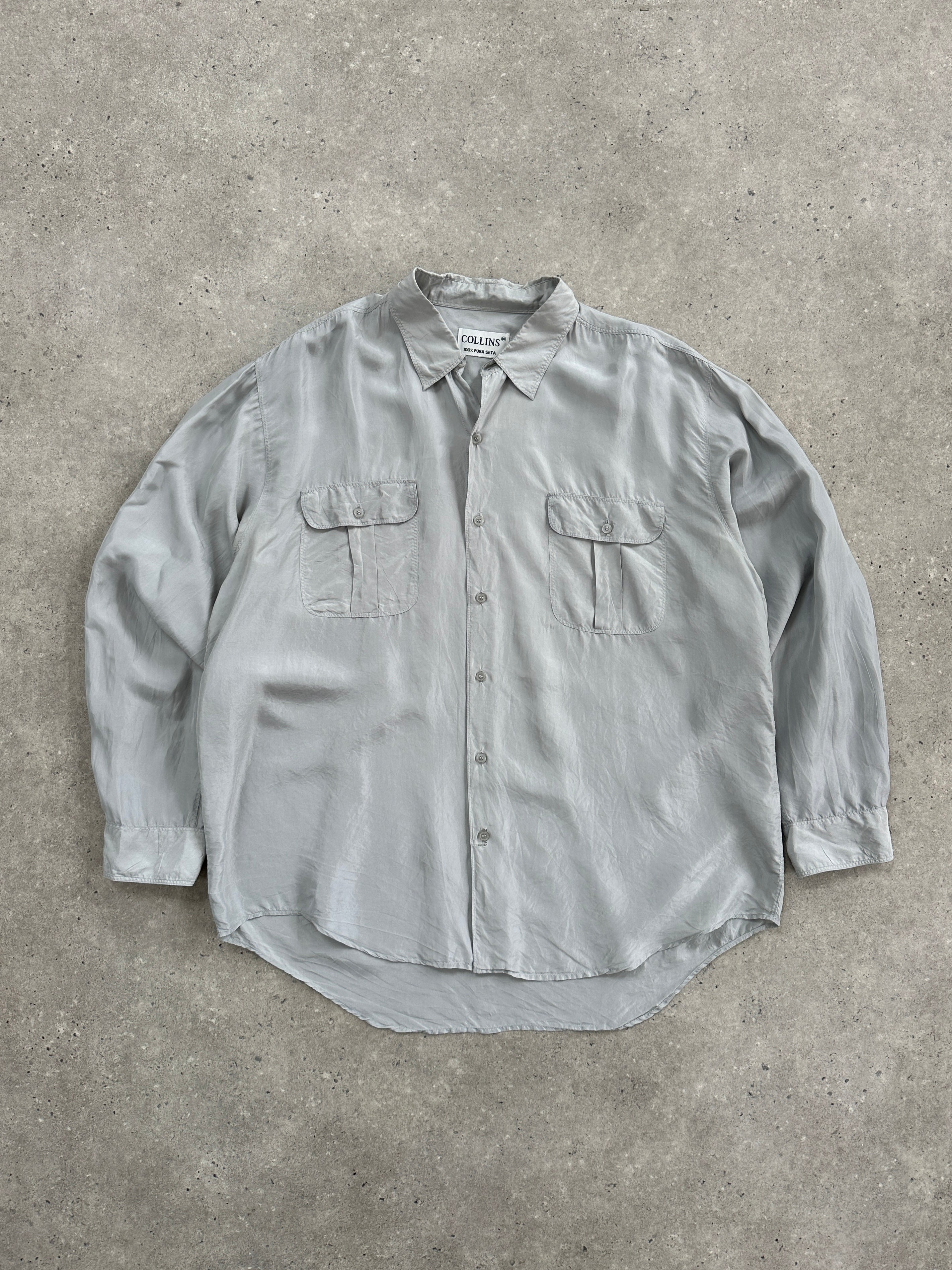 Vintage 1990s relaxed pure silk shirt in XL size, featuring classic design and soft fabric, displayed on a hanger.