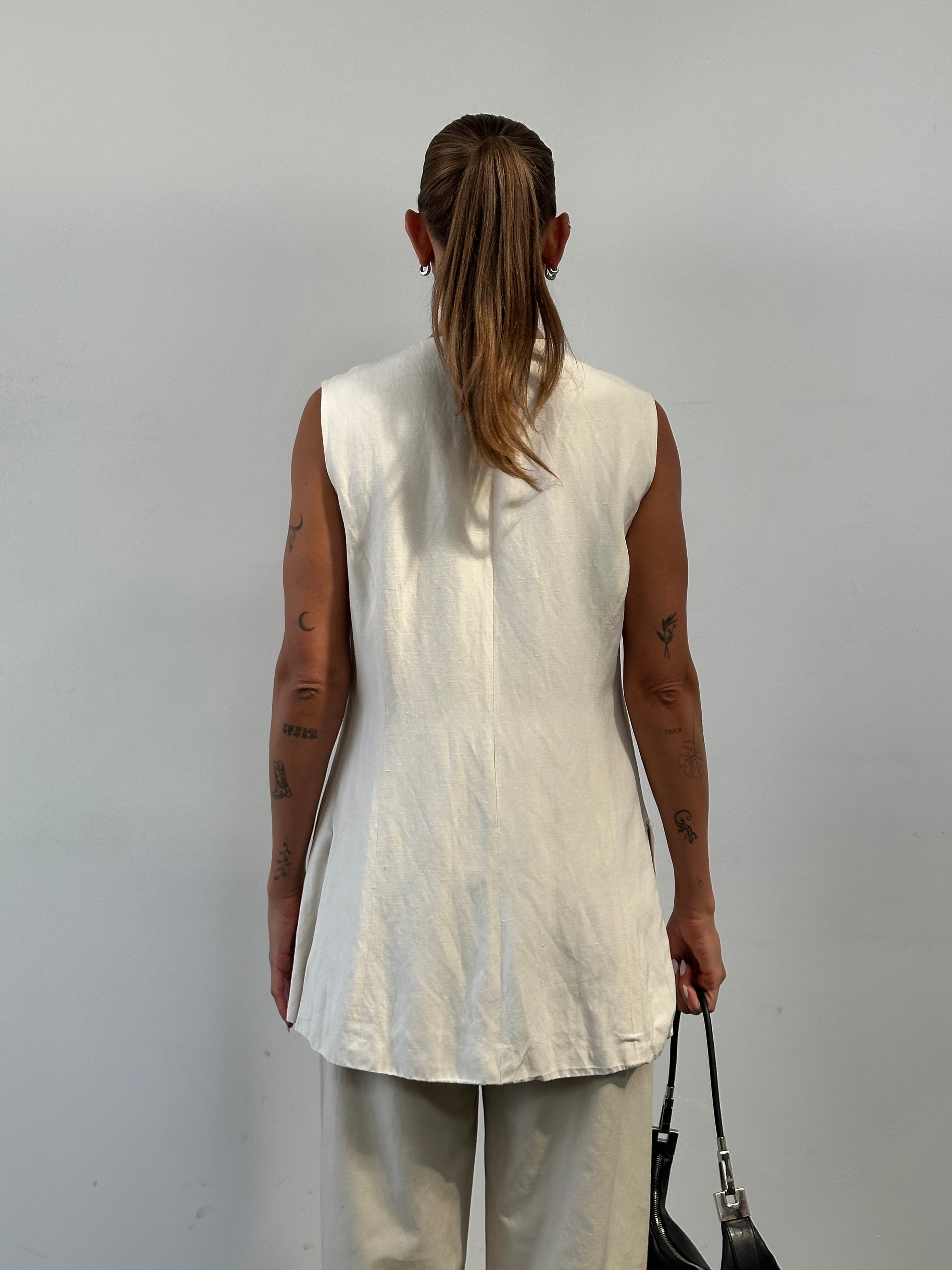 Laura Ashley silk linen waistcoat in size L, shown on a hanger, featuring a classic tailored design and neutral color.