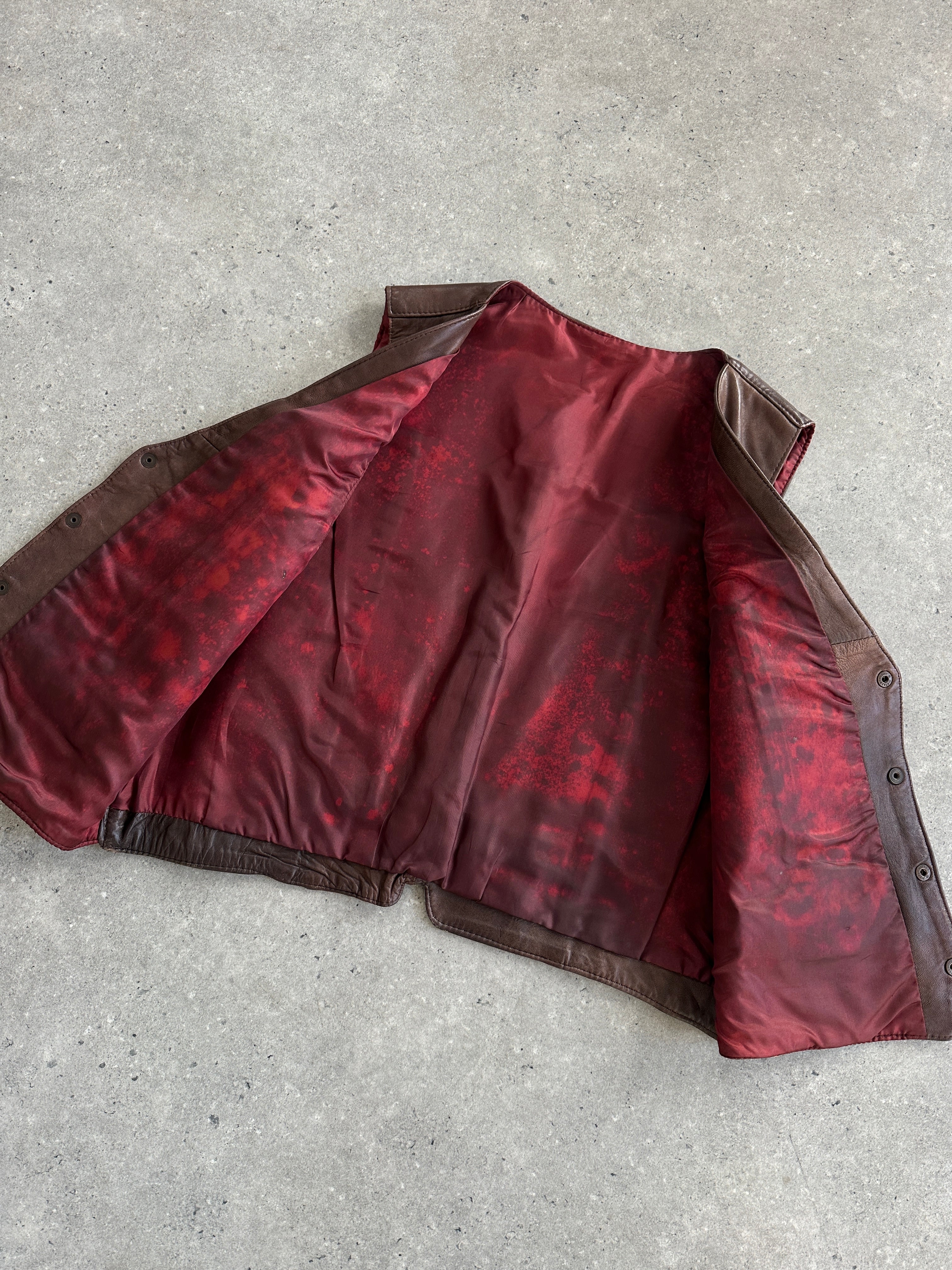 Vintage Italian vintage aged leather waistcoat in size large, featuring classic craftsmanship and rich brown leather details.