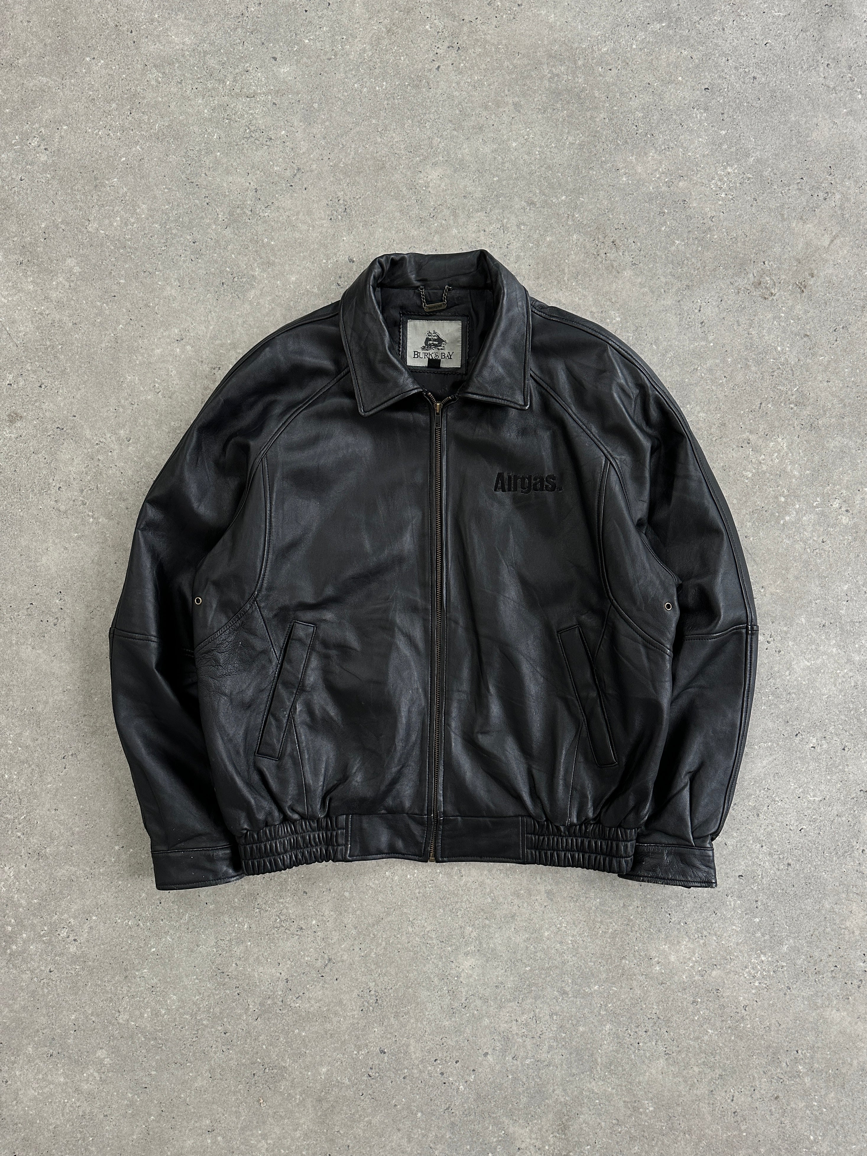 Vintage leather bomber jacket with vintage embroidery, size L/XL, featuring classic design and detailed stitching.