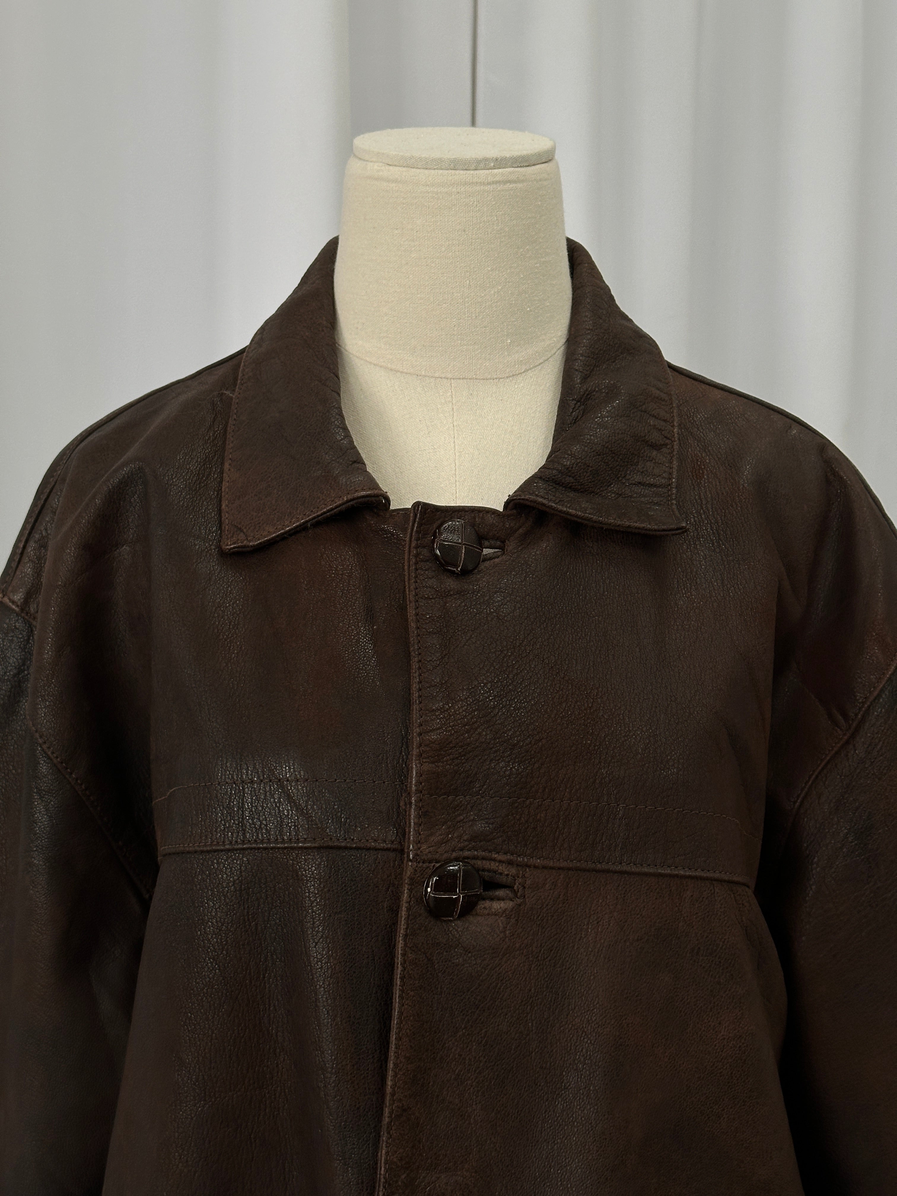 Vintage brand vintage 1980s boxy leather jacket in aged leather, size XL, with classic distressed appearance and structured fit.