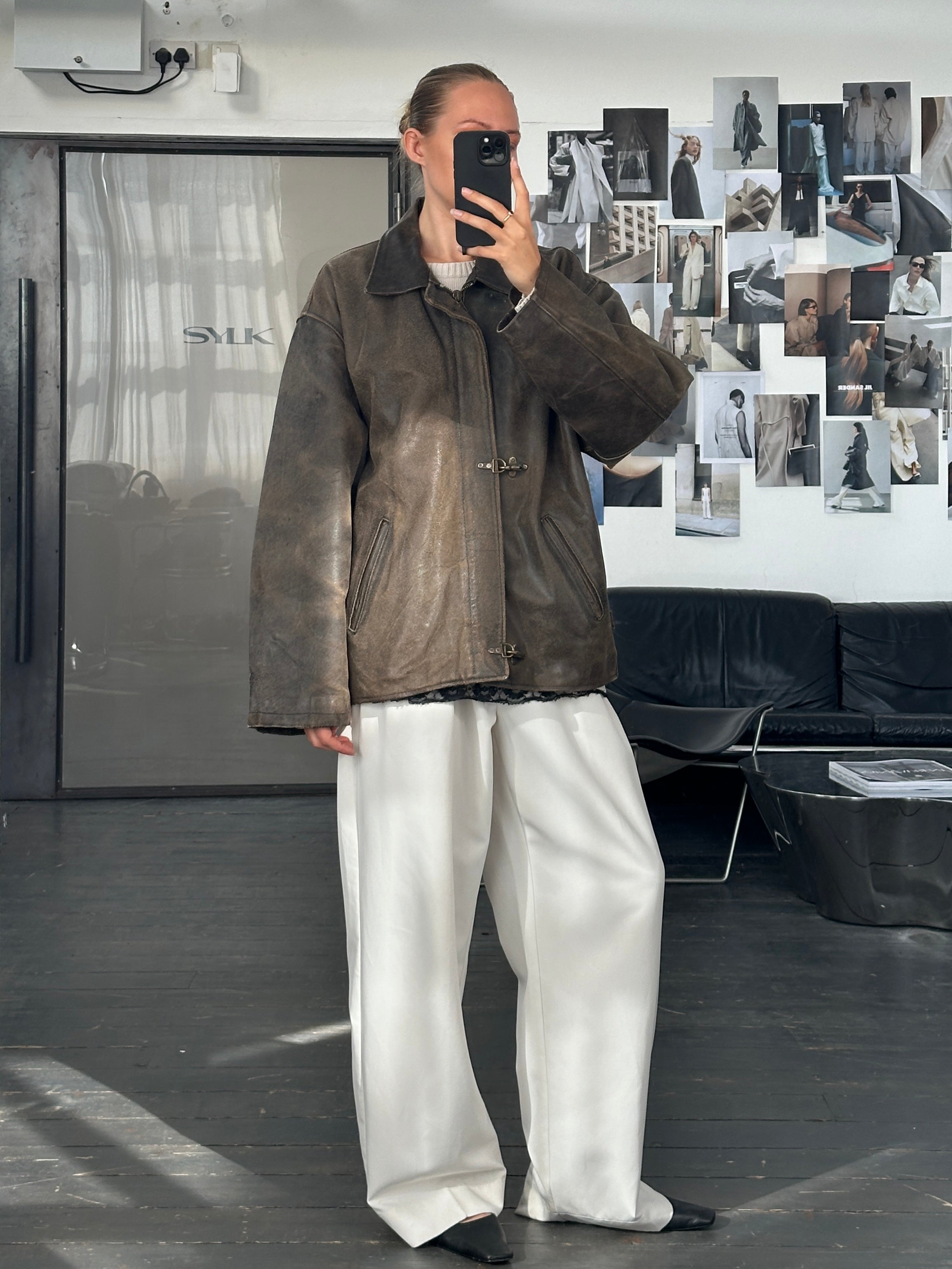 Vintage brand distressed leather jacket from the 1980s in XL size with a rugged, worn-in look and classic style.