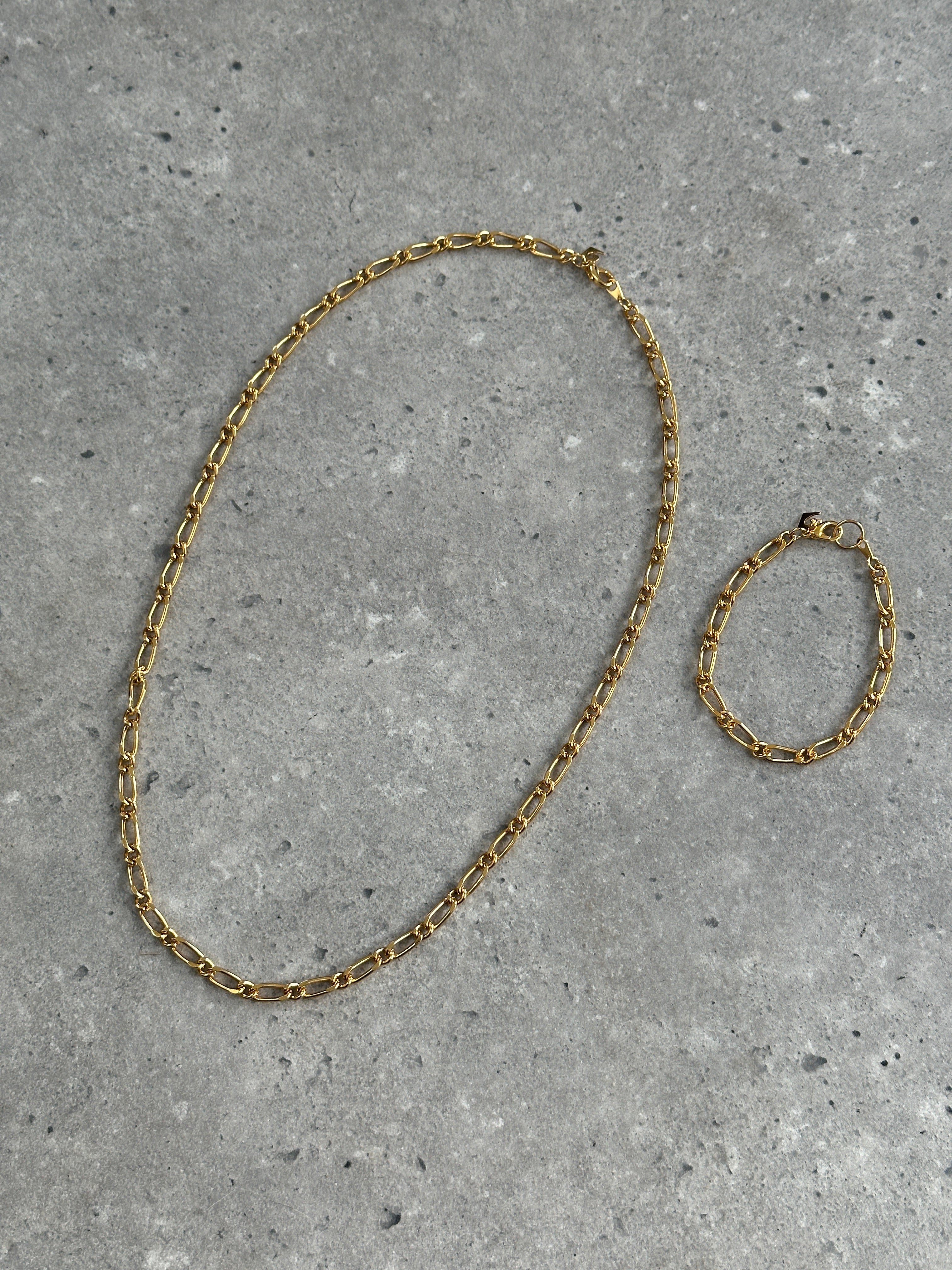 Pierre Cardin gold plated necklace and bracelet chain set with elegant links and polished finish, suitable for stylish accessories.