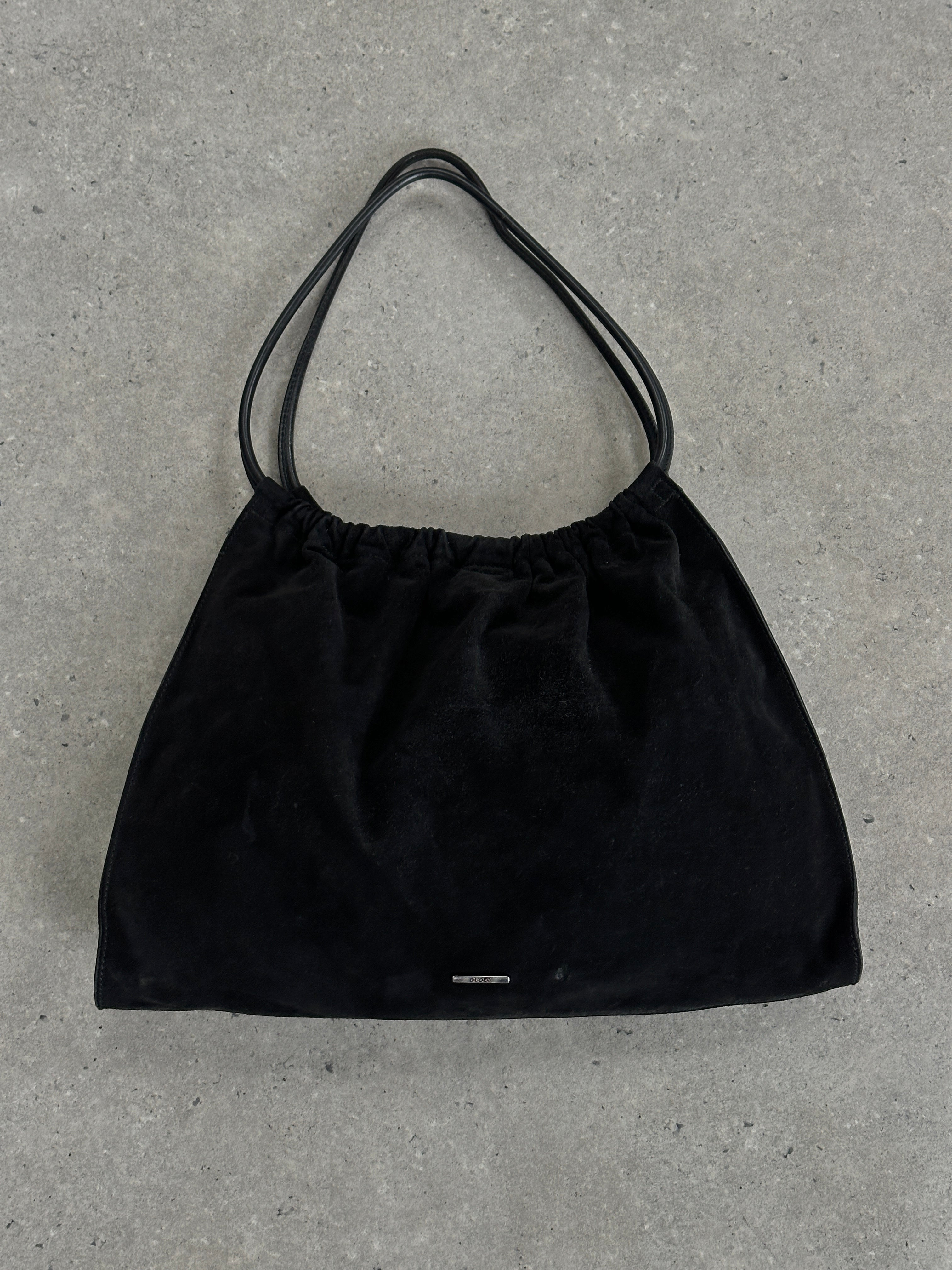 Gucci 1990s Tom Ford suede leather hobo shoulder bag with slouchy design and top handle, vintage luxury accessory.