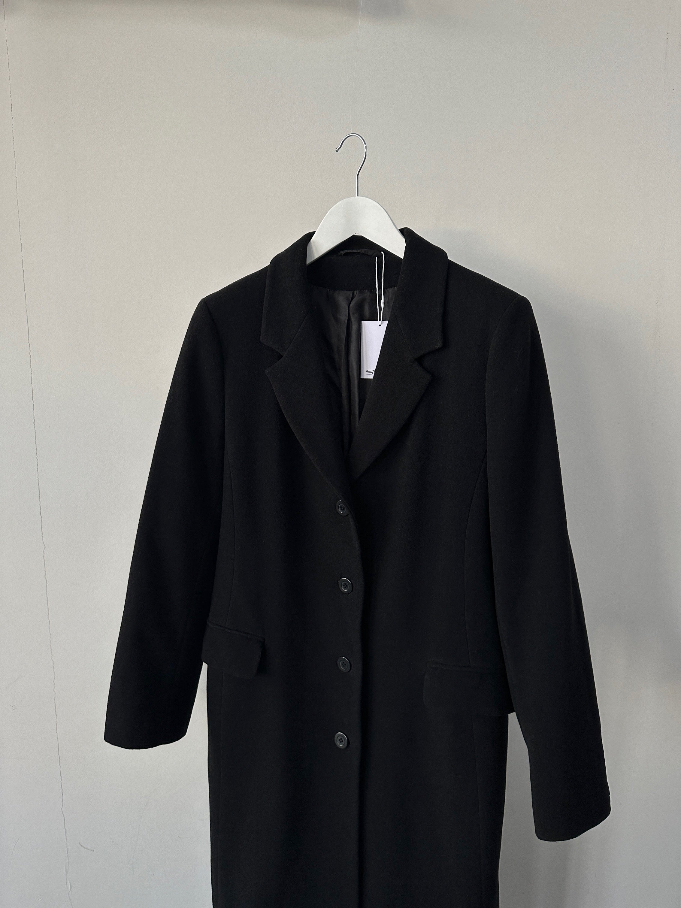 Vintage wool coat, floor-length single-breasted design in size M, shown hanging on a wooden hanger with classic styling.