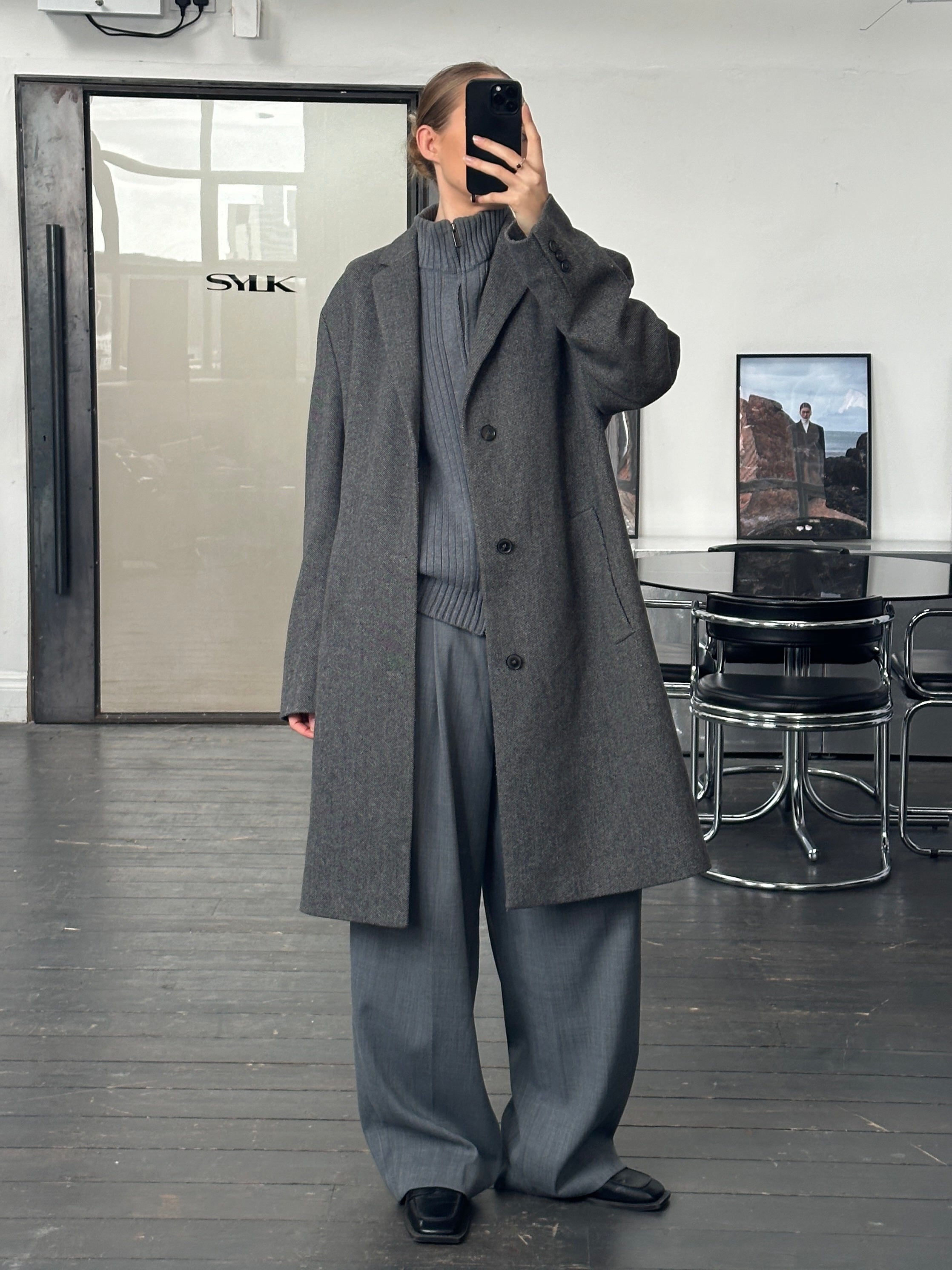 Hugo Boss 1990s wool single-breasted coat in XXL, dark color, shown hanging with lapels and button details.