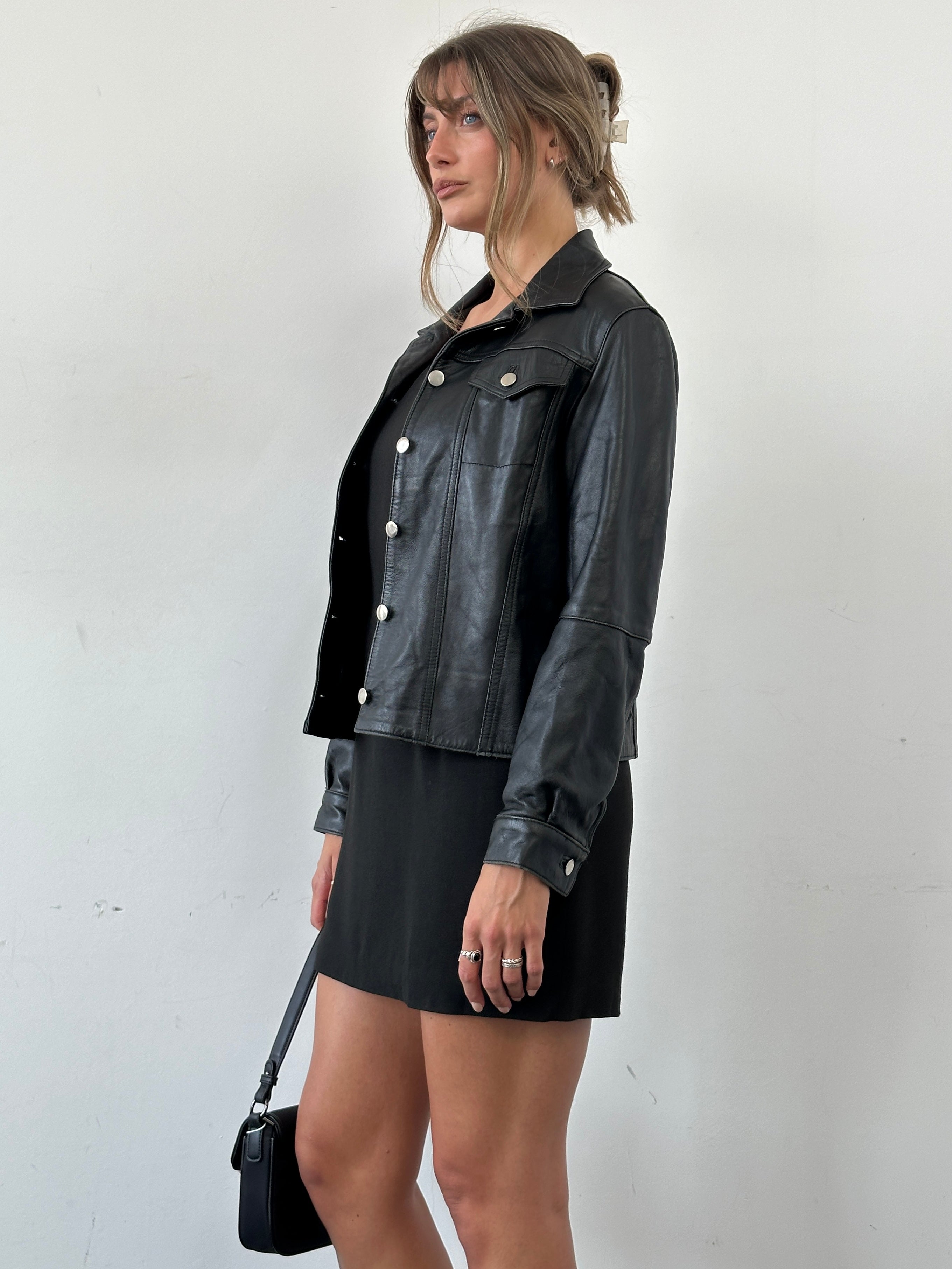 Vintage Italian leather jacket with button-up front, classic style, in size S/M, featuring a rugged, vintage leather finish.