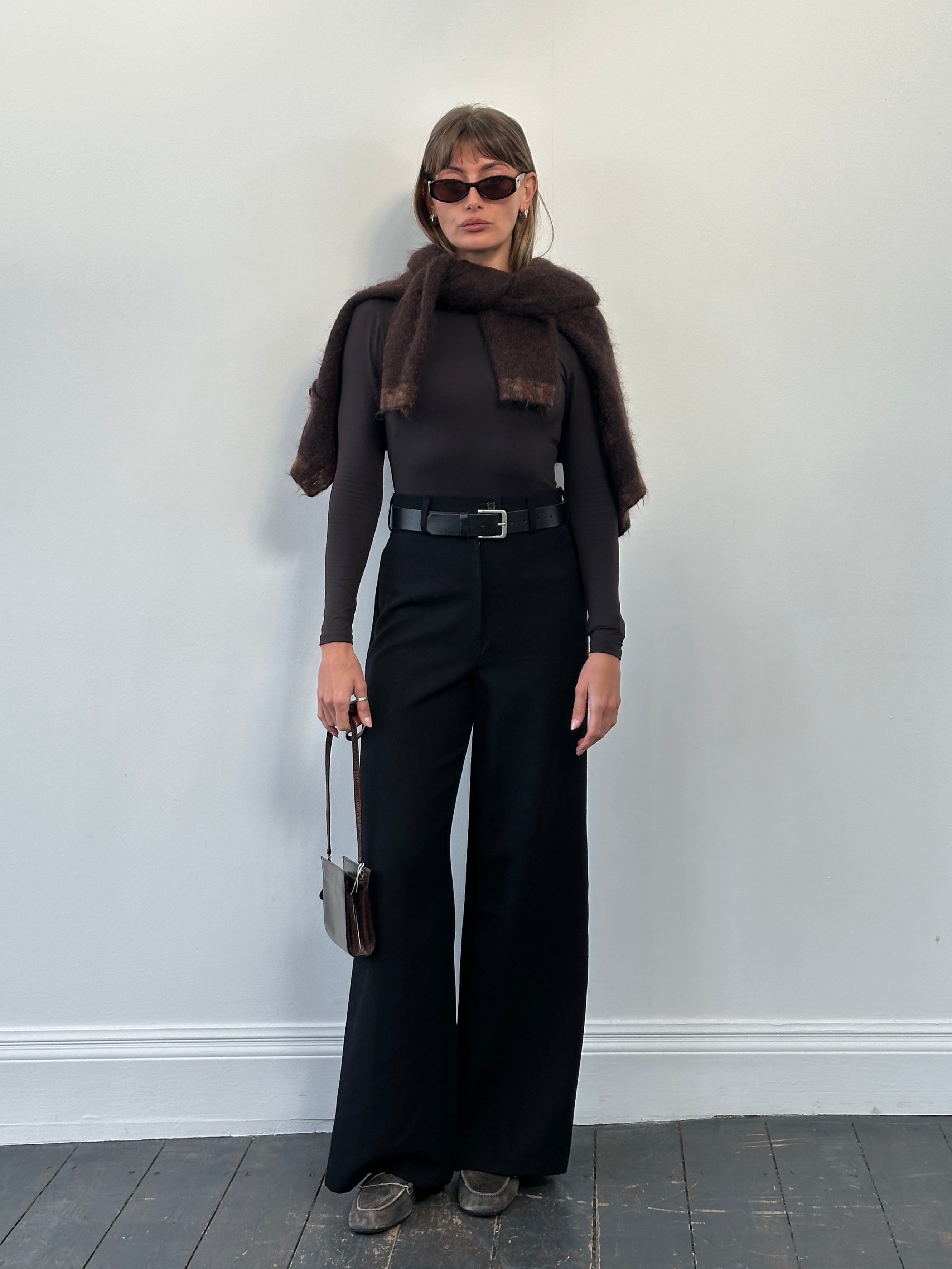 Vintage 1990s pure wool wide leg tailored trousers in size W26, showcasing a classic cut and deep navy color.
