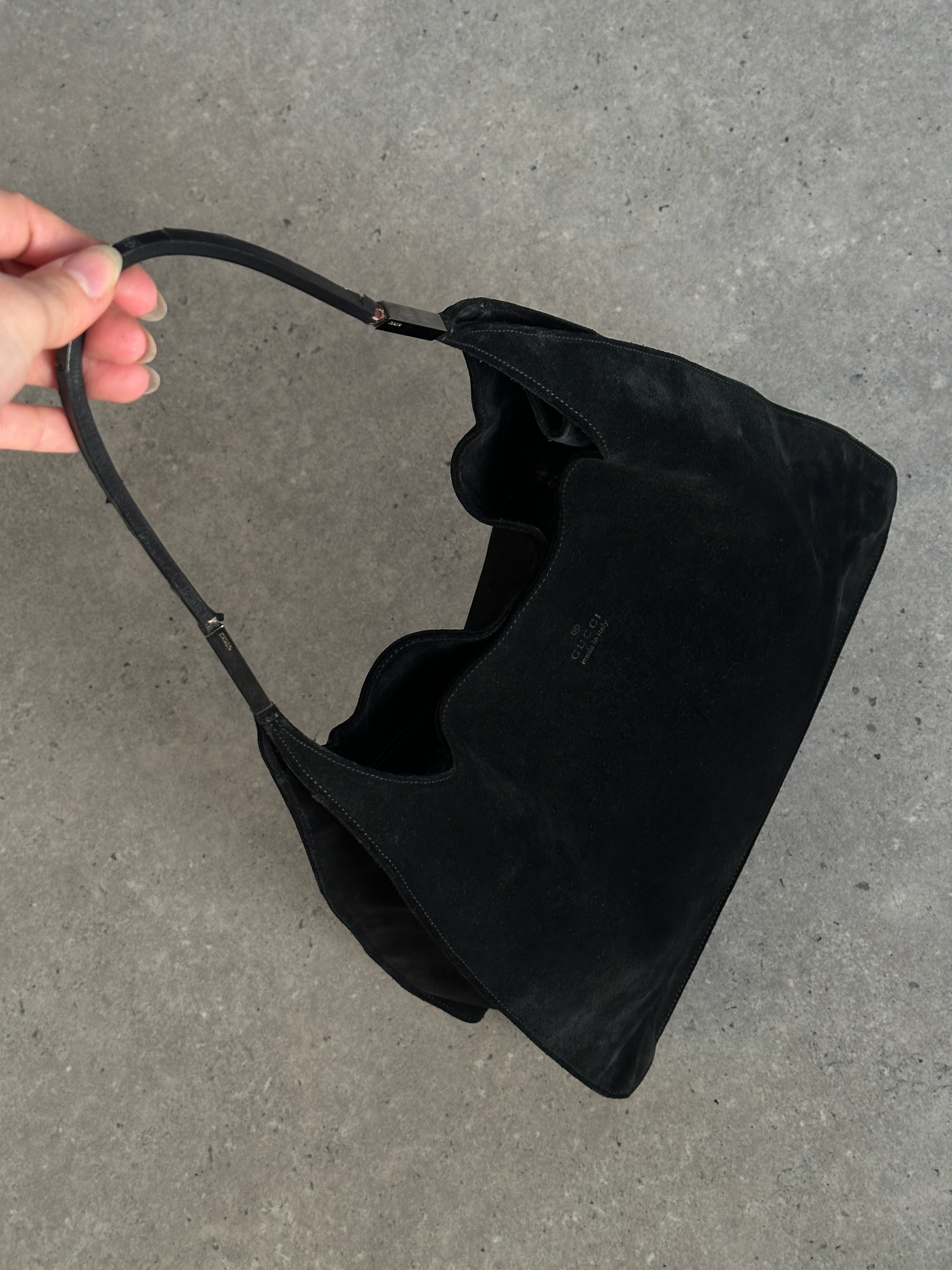 Gucci suede shoulder bag with gold-tone hardware, featuring a sleek design and adjustable strap for stylish carrying.