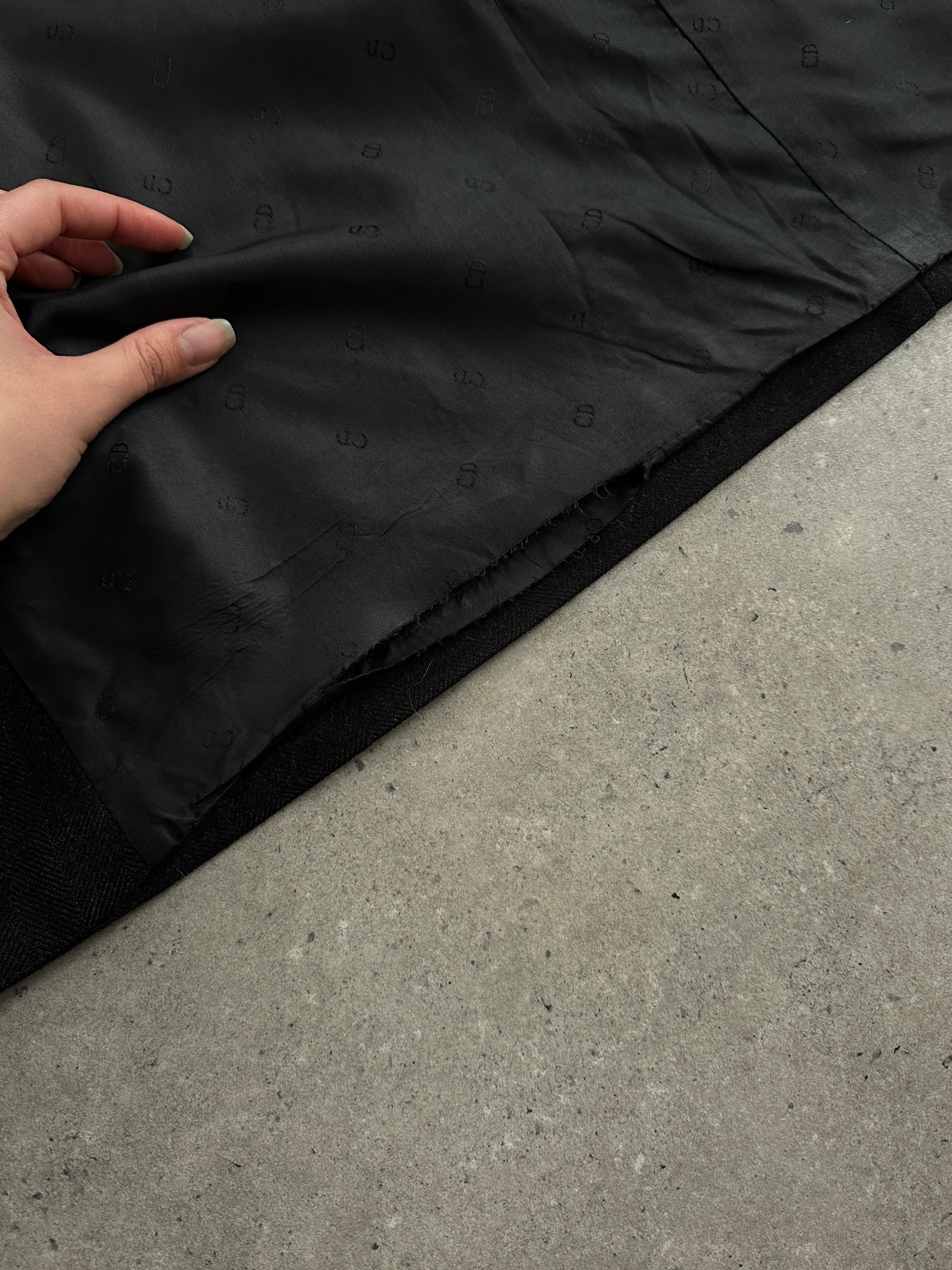 Christian Dior pure wool double-breasted coat in size L/XL displayed on a hanger, showcasing classic tailored design.