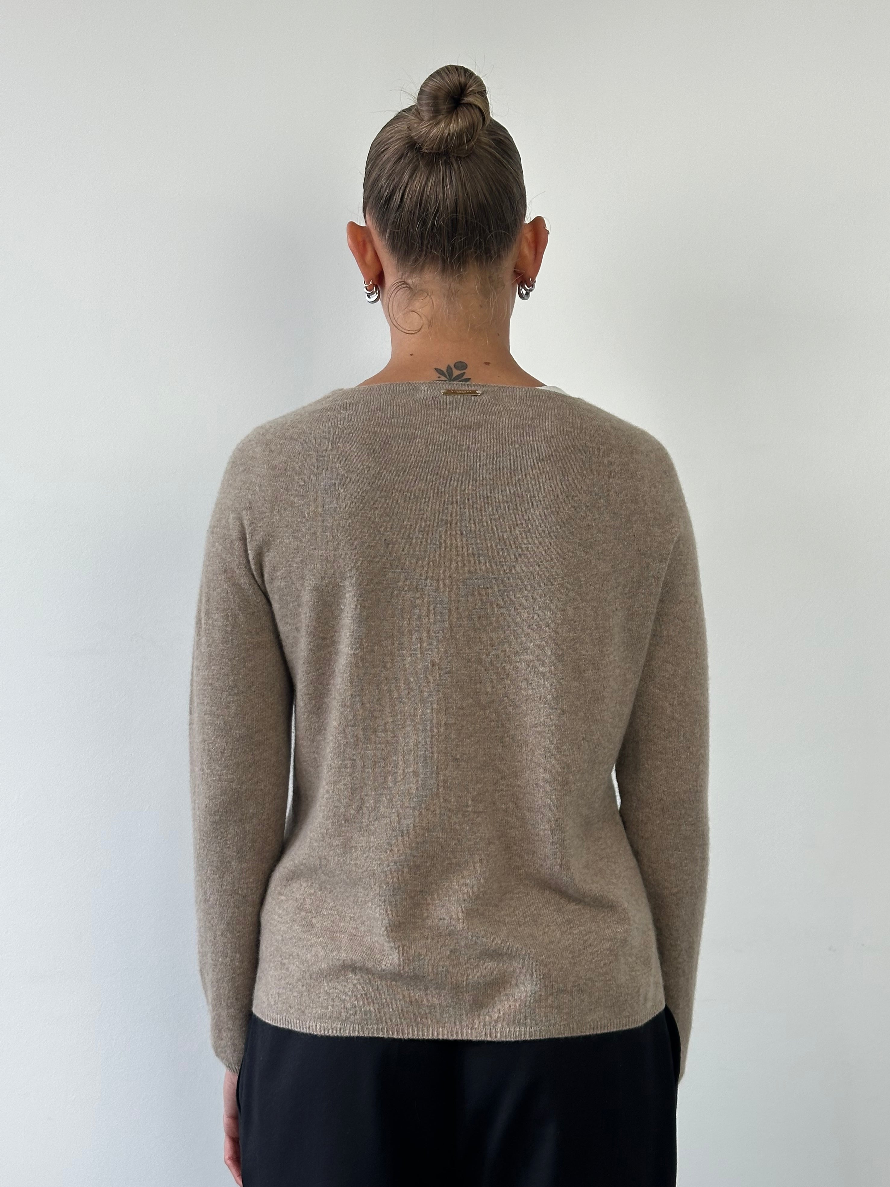 Burberry London pure cashmere lightweight knitted jumper in soft beige, displayed on a hanger.