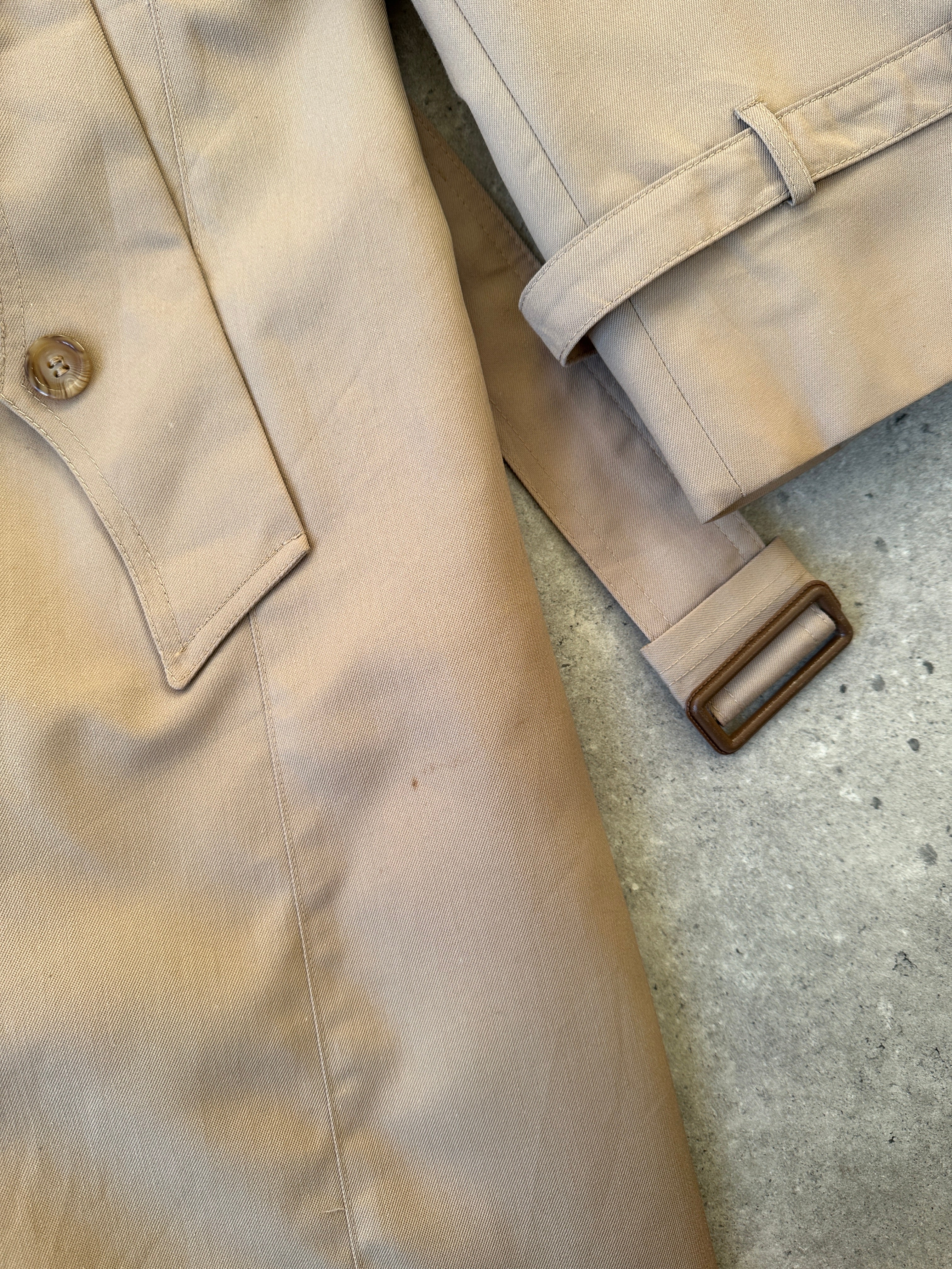 Christian Dior double-breasted cotton trench coat with belt, stylish and classic, shown in a natural pose.