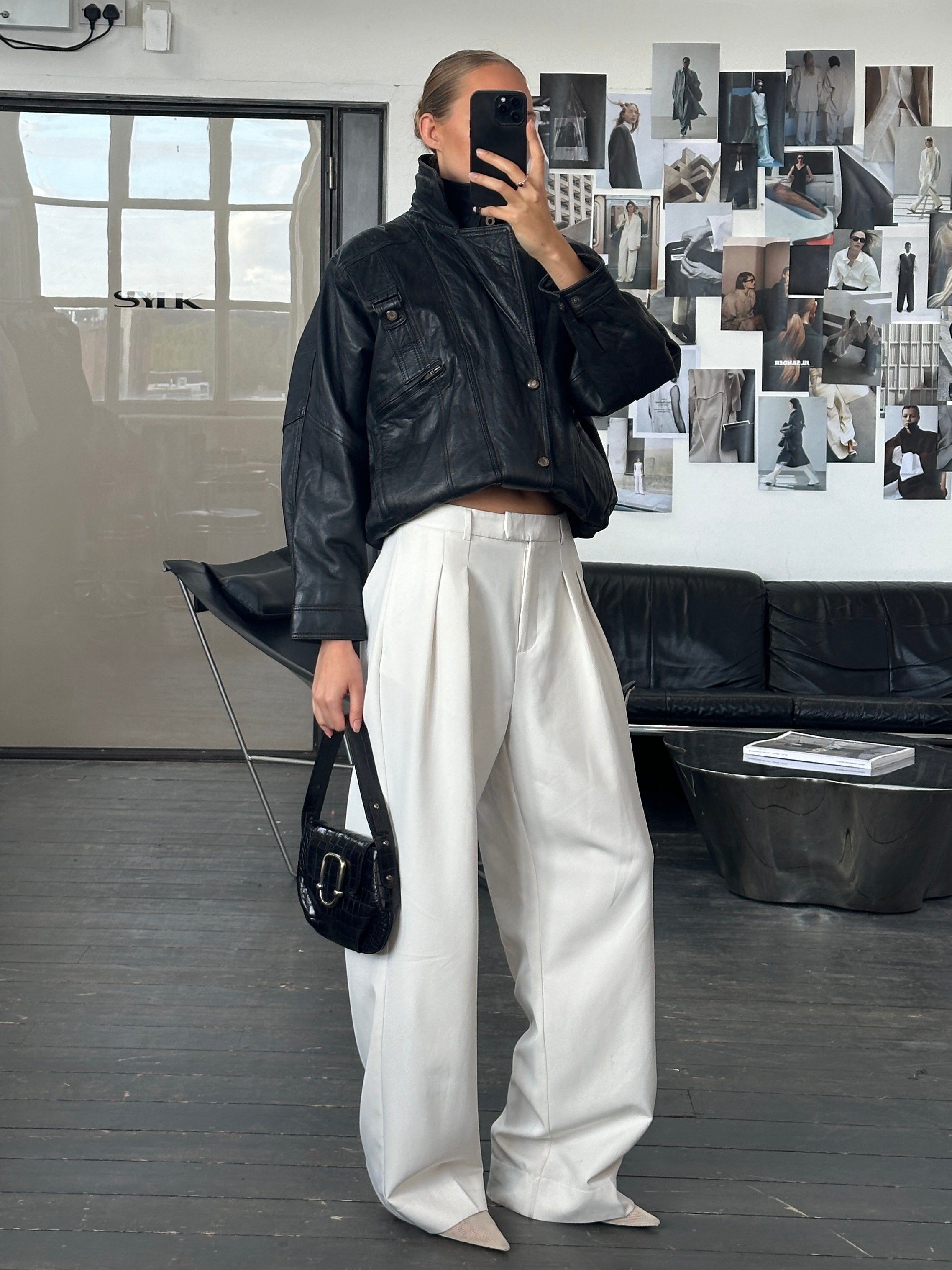 Vintage 1990s high neck leather bomber jacket, stylish men's leather jacket with classic design and textured leather surface.