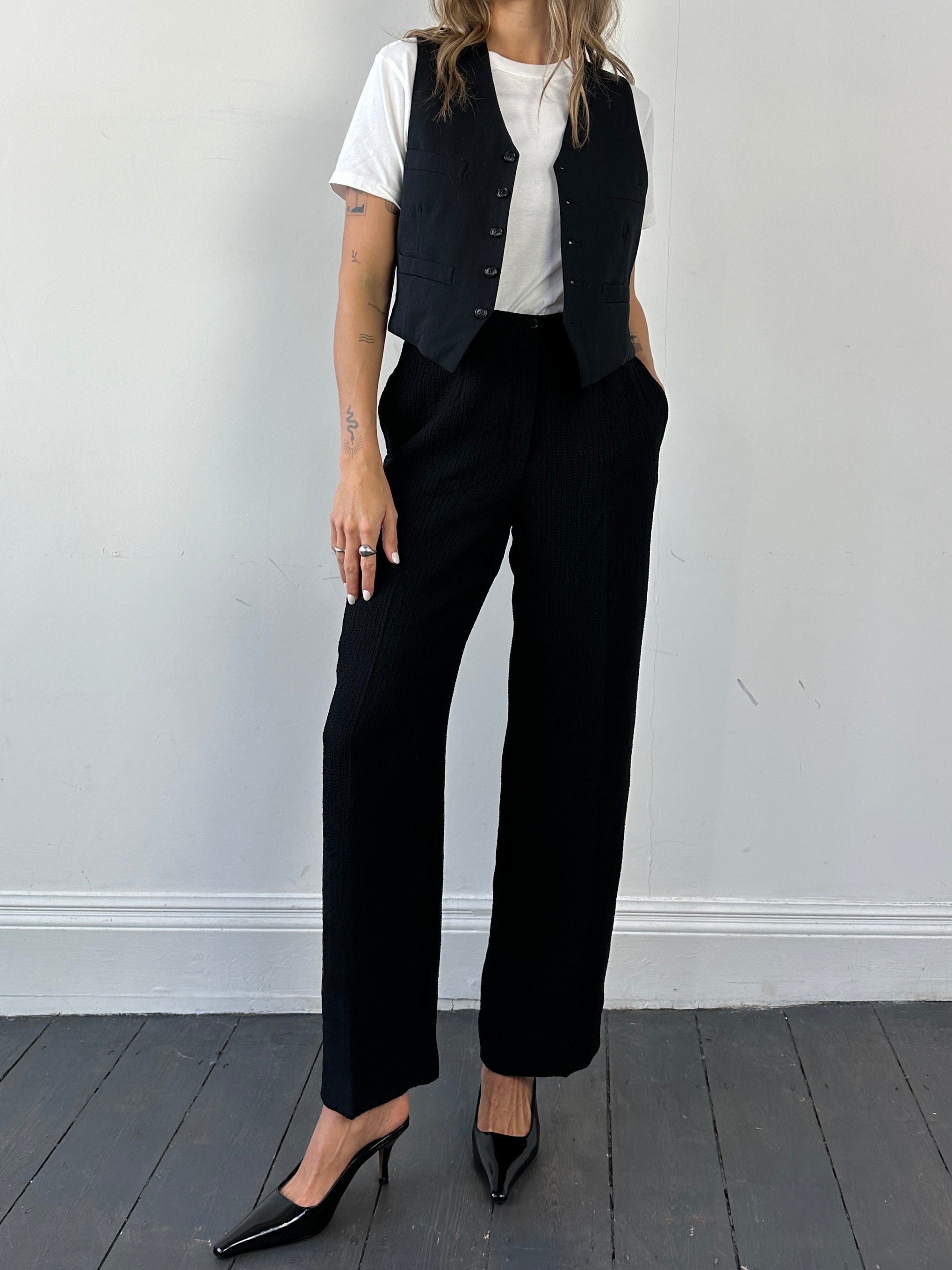 Vintage high-waisted textured trousers in size W26, featuring a classic fit and detailed fabric pattern.