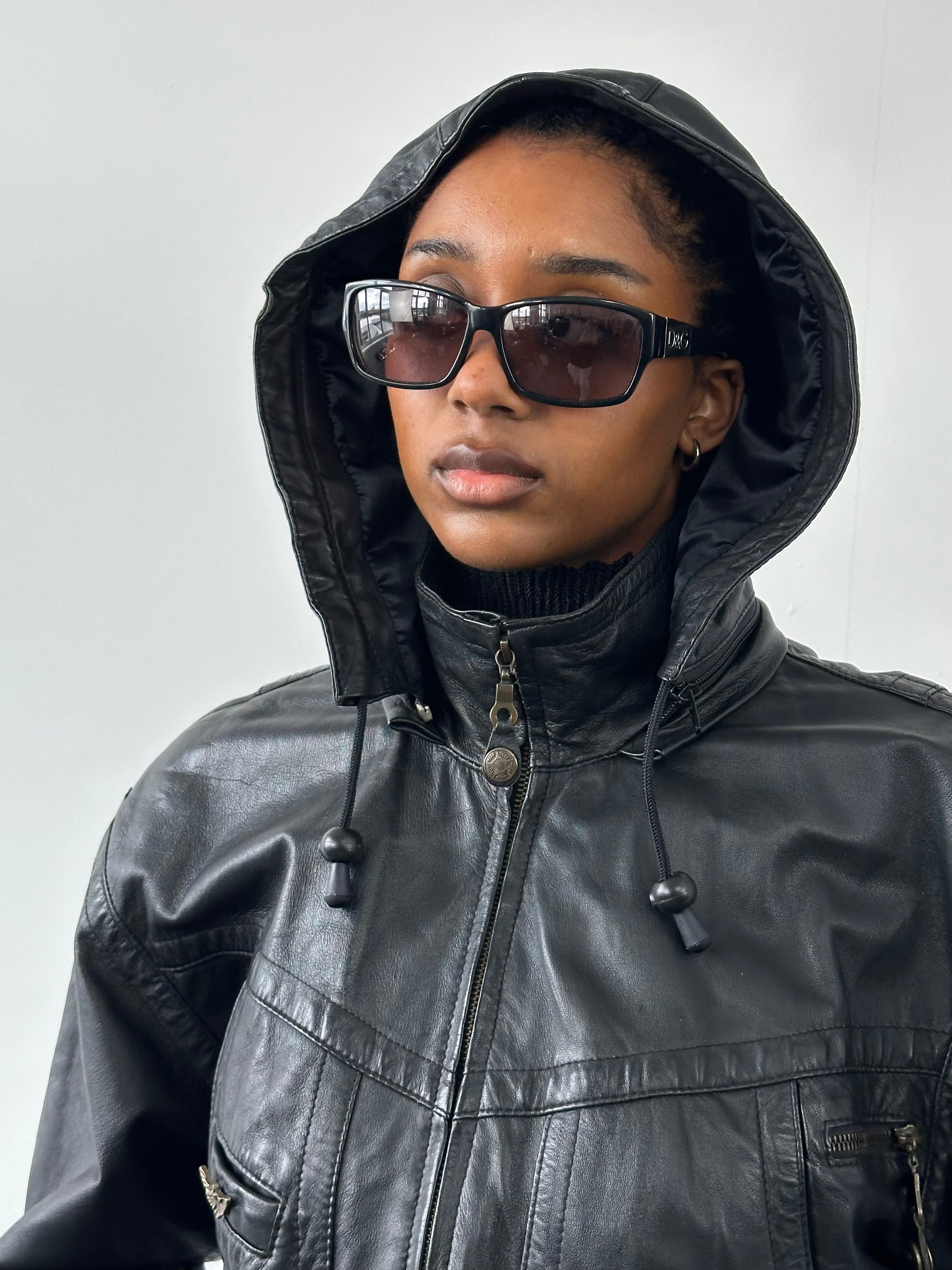 Vintage 1990s leather funnel neck hooded bomber jacket, size S, featuring a classic distressed leather finish and rugged style.