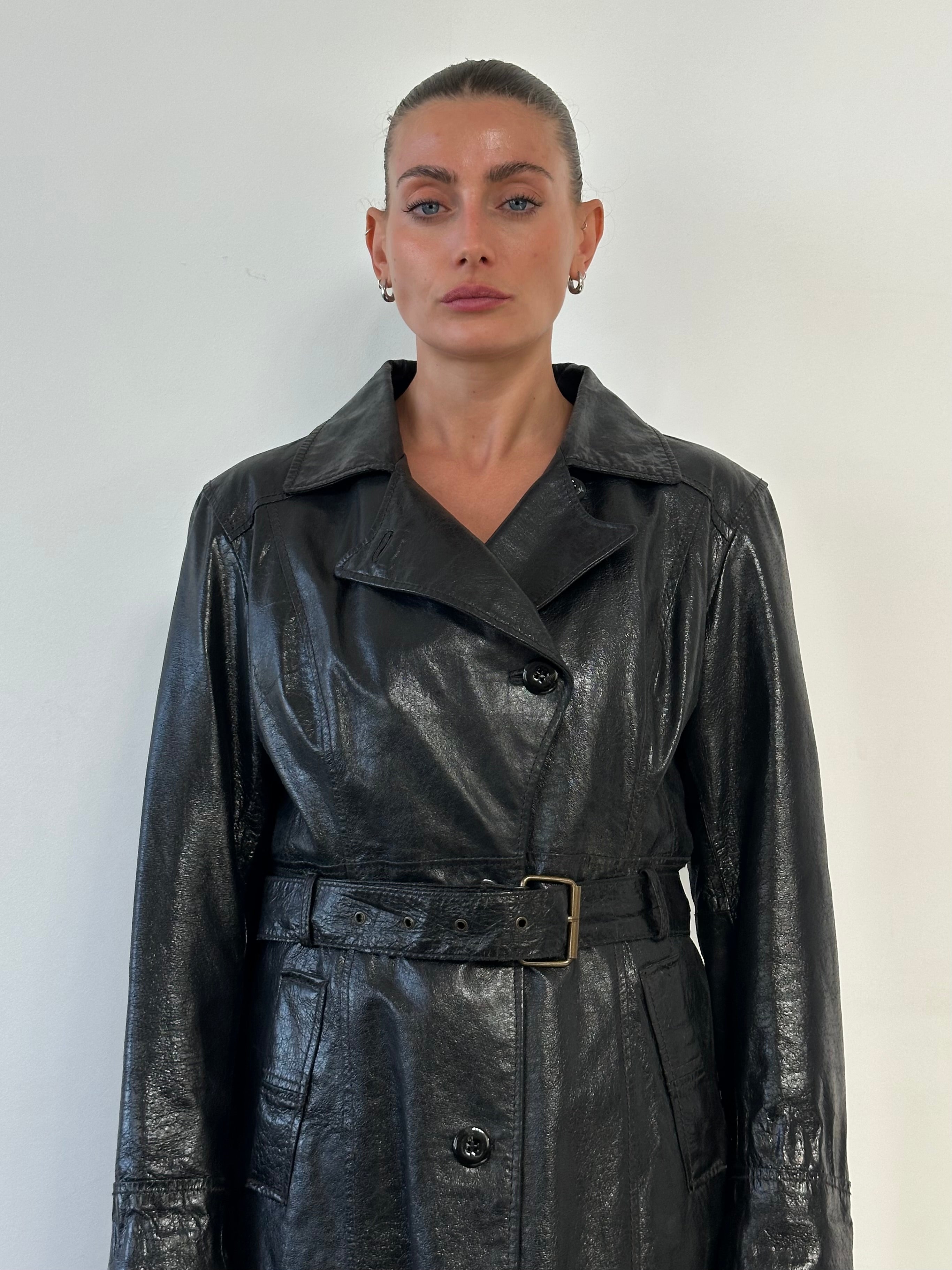 Conbipel leather belted trench coat for women, stylish jacket with tailored fit and classic design, shown in the image.
