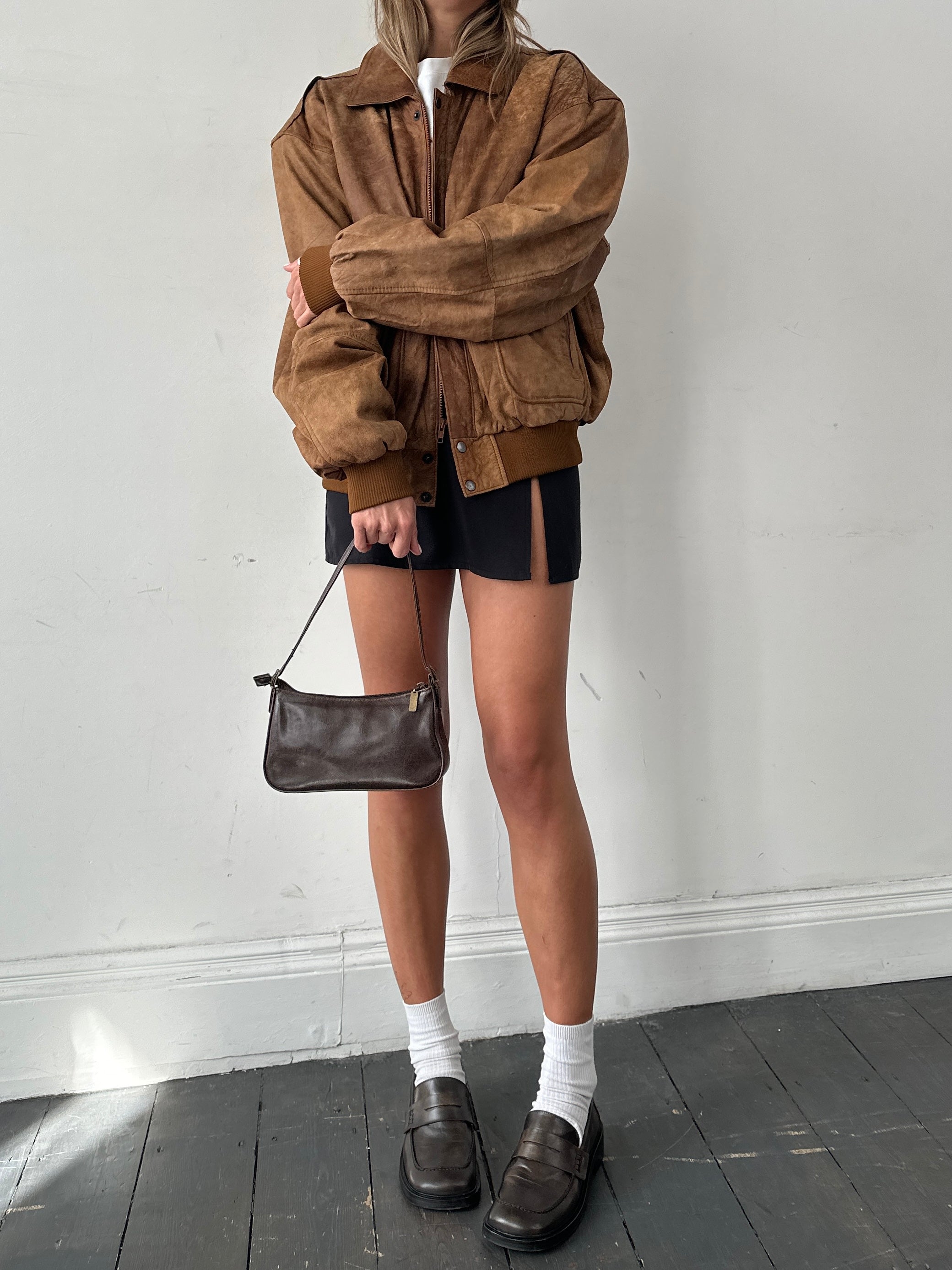 Vintage aged leather bomber jacket in XL size, featuring classic design and distressed leather texture.