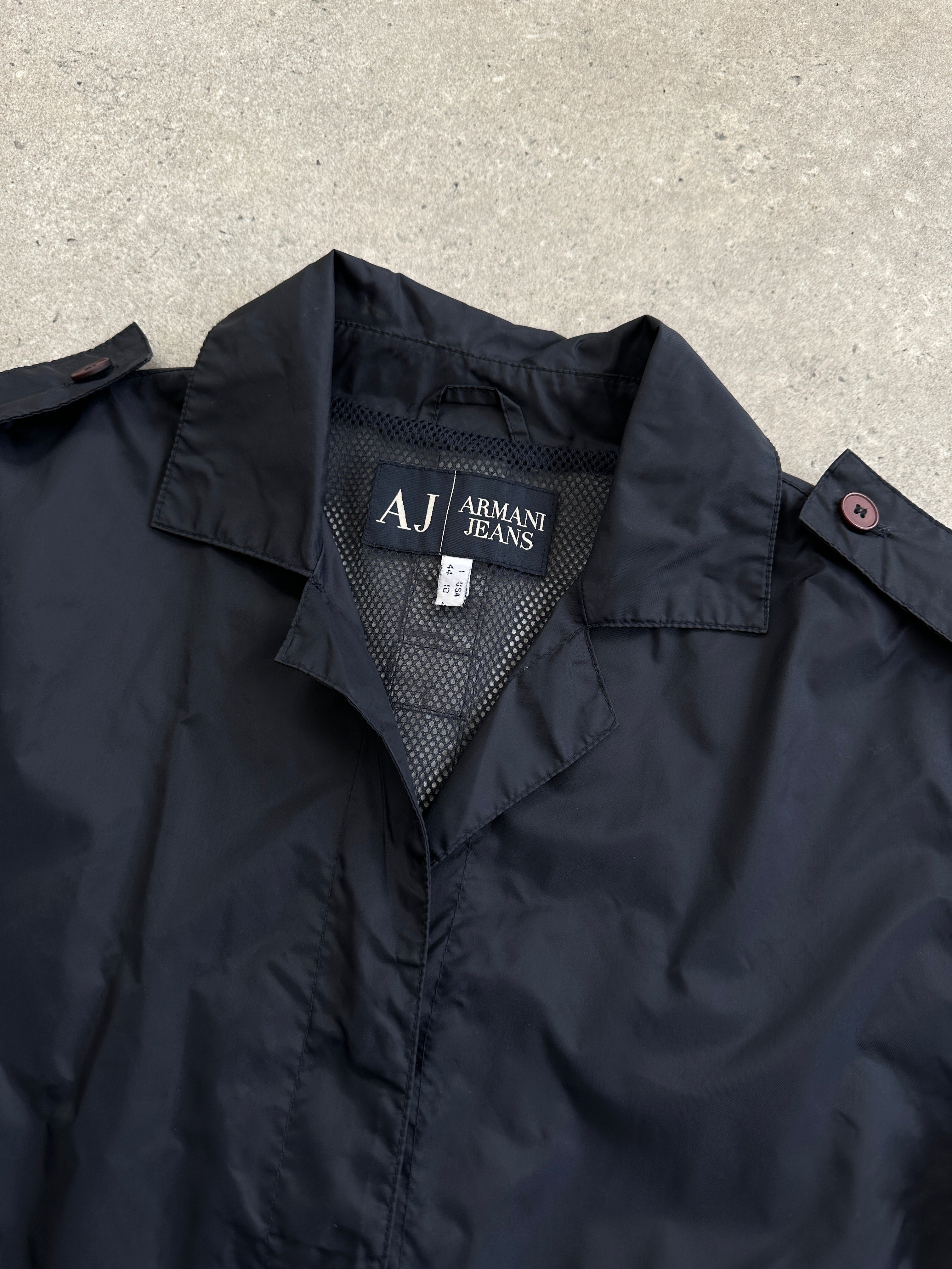 Armani Jeans 1990s showerproof nylon lightweight logo jacket in S/M, shown in black with Armani branding and zip closure.