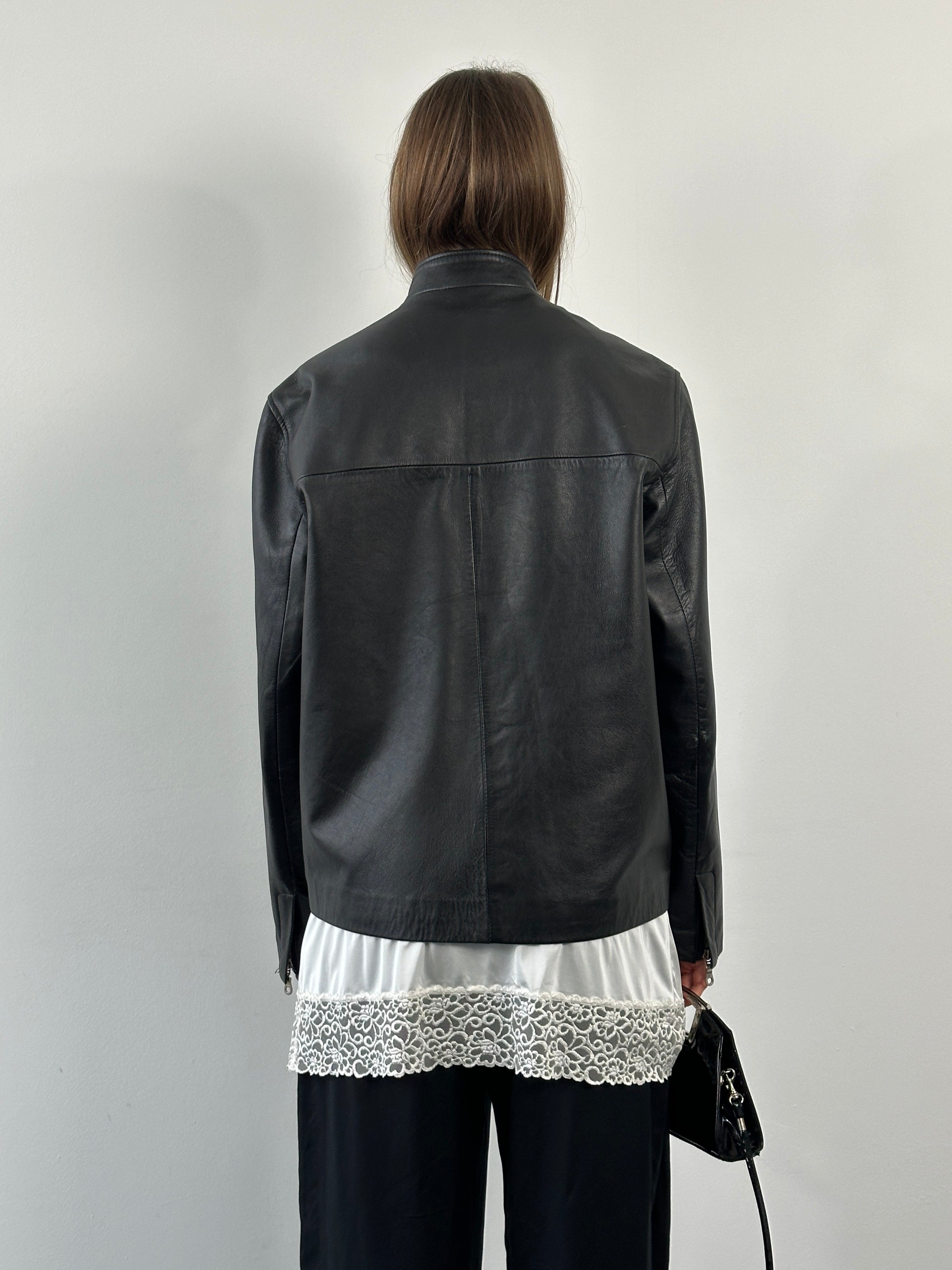 Vintage 2000s minimal high neck leather jacket in black, featuring a sleek design and classic silhouette, size M/L.
