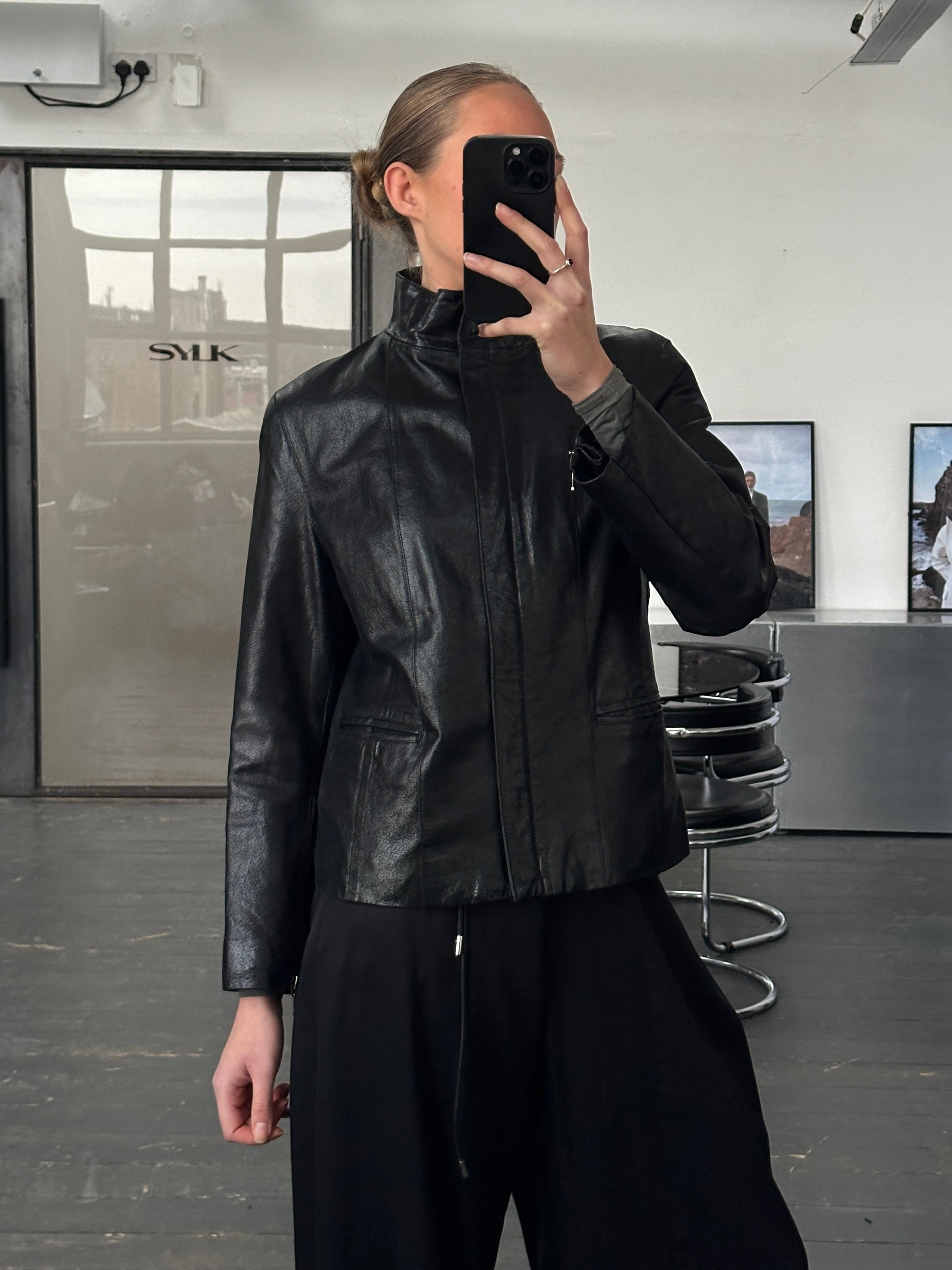 Vintage 1990s high neck leather jacket with double zippers, in black leather, featuring a classic retro style and tailored fit.