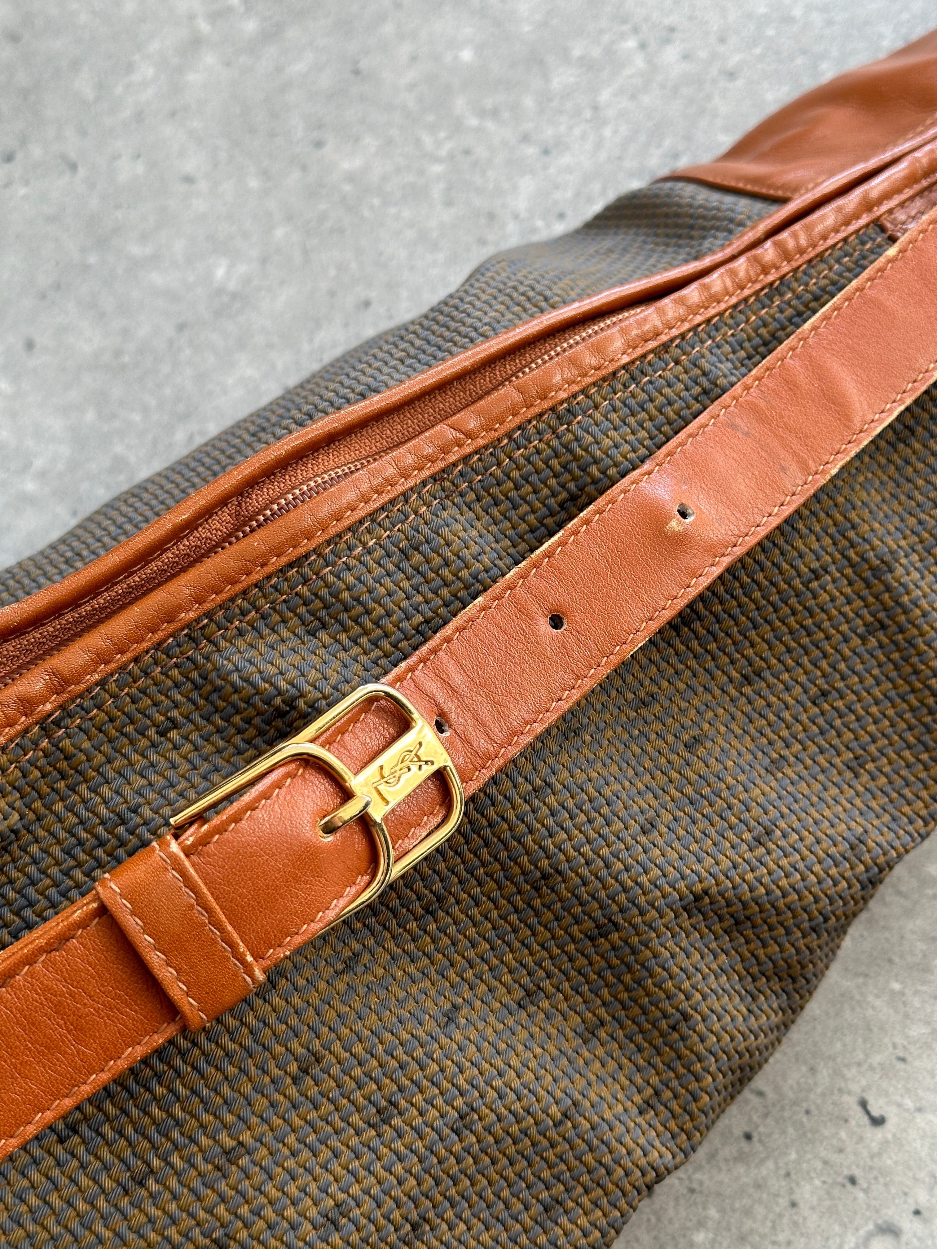 Yves Saint Laurent Paris 80s leather sling bag with sleek design and adjustable strap, showcasing classic YSL branding.